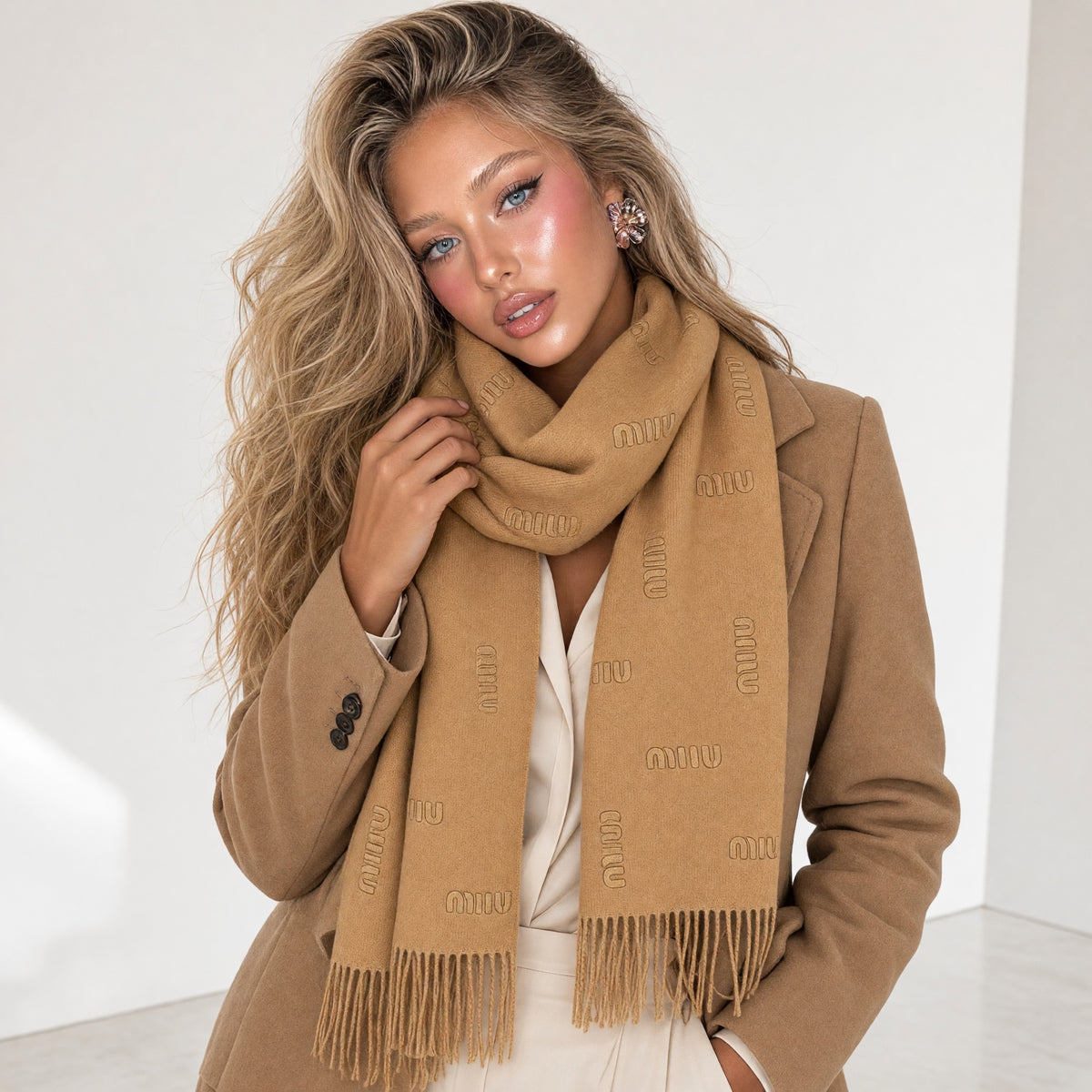 camel Miu Miu logo scarf with fringe draped on model