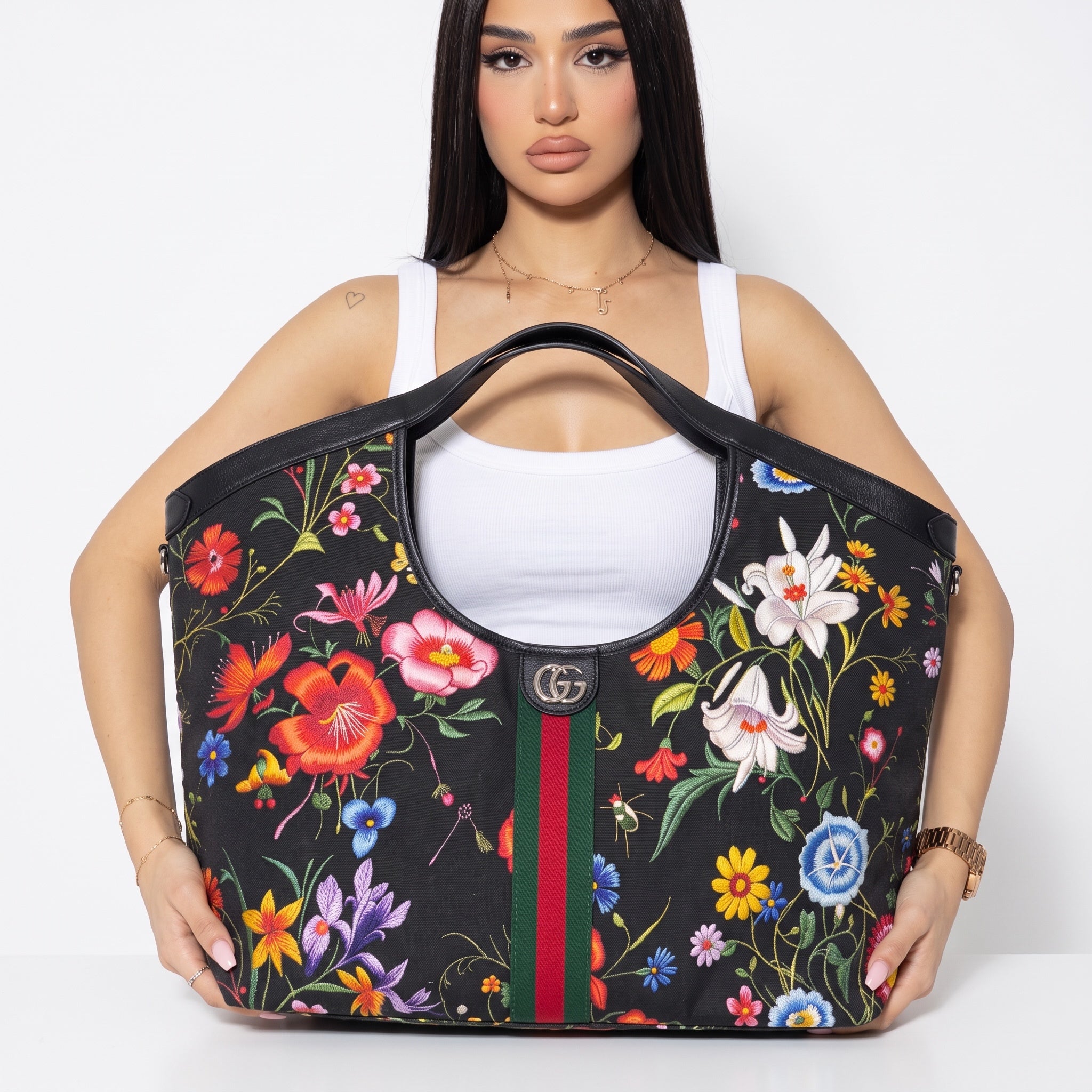 Black Gucci tote with colorful floral print, GG logo and green-red-green stripe
