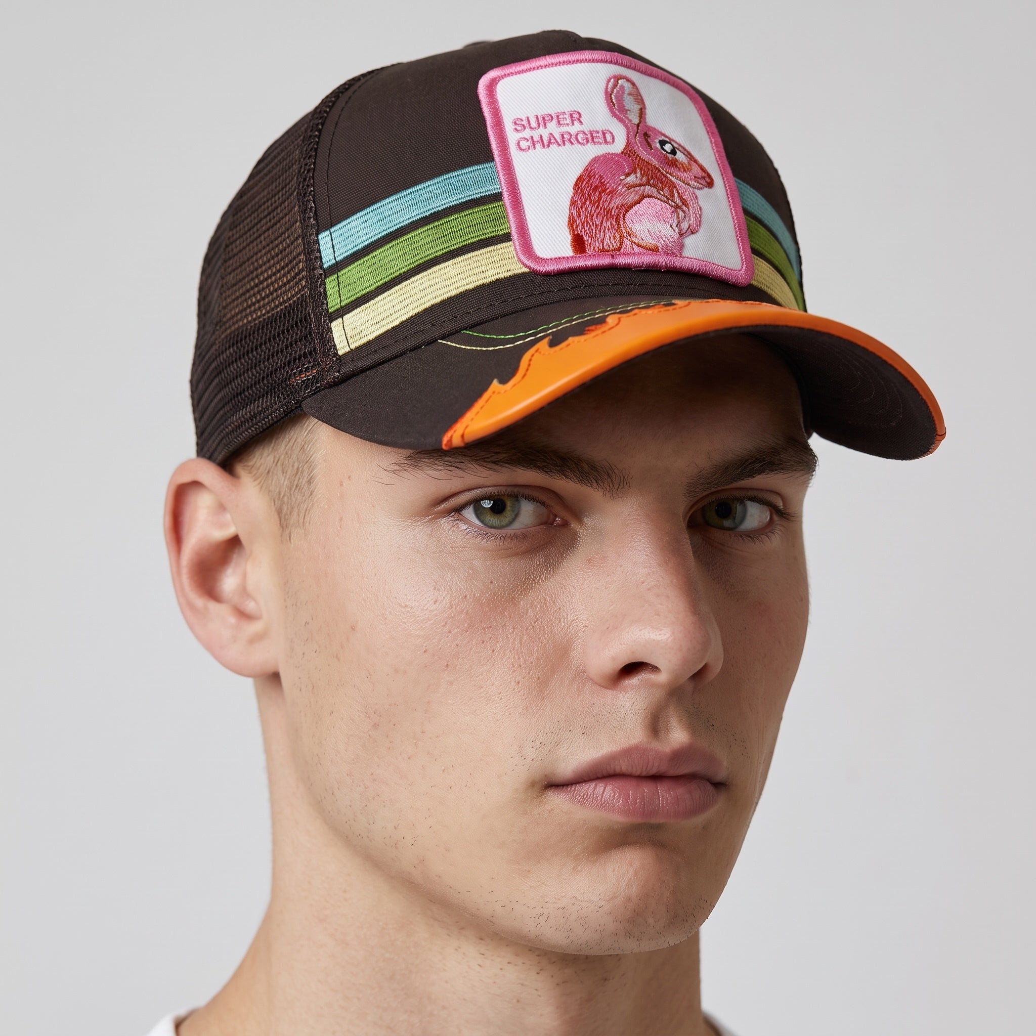 brown trucker cap with pink bunny patch, pastel stripes and orange brim trim