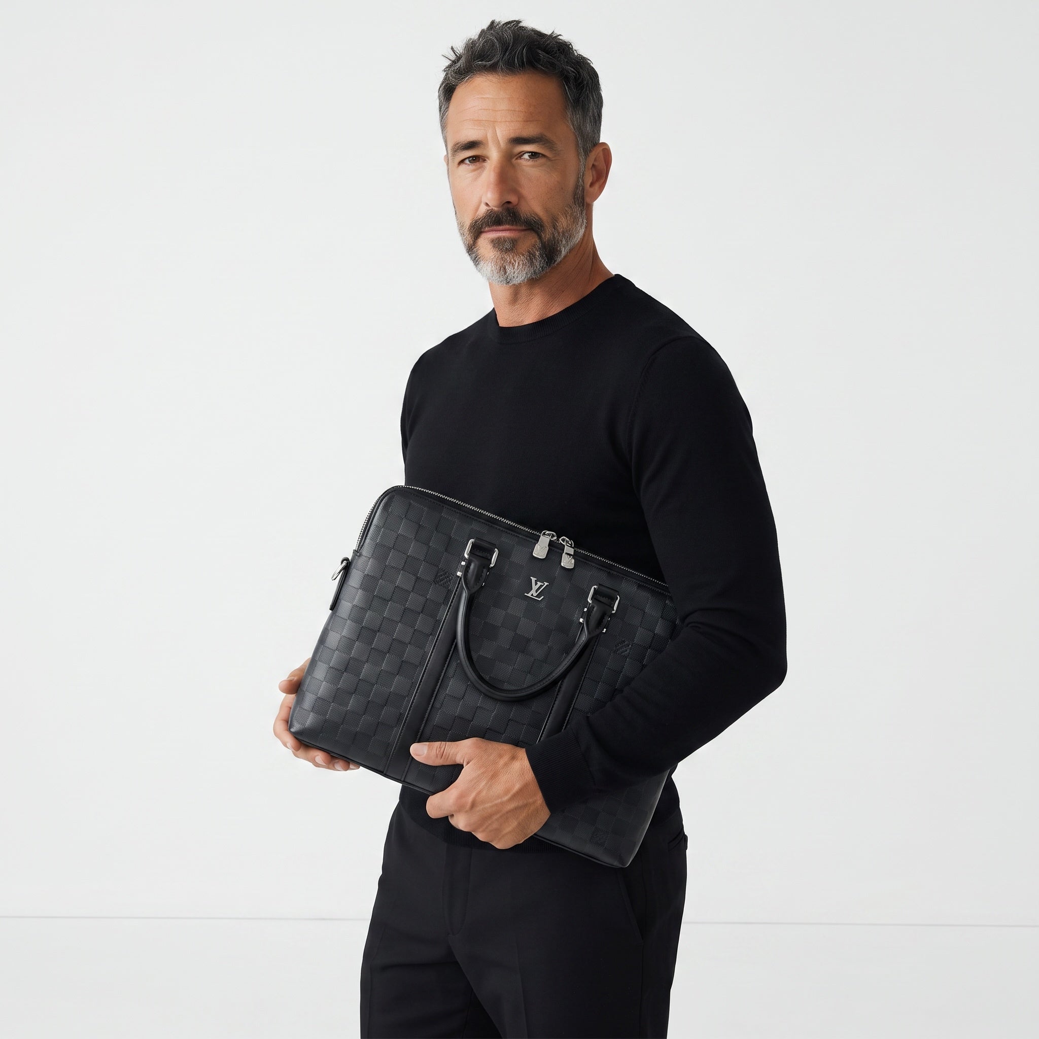 Man holding a black Louis Vuitton Damier briefcase with LV logo and silver zippers