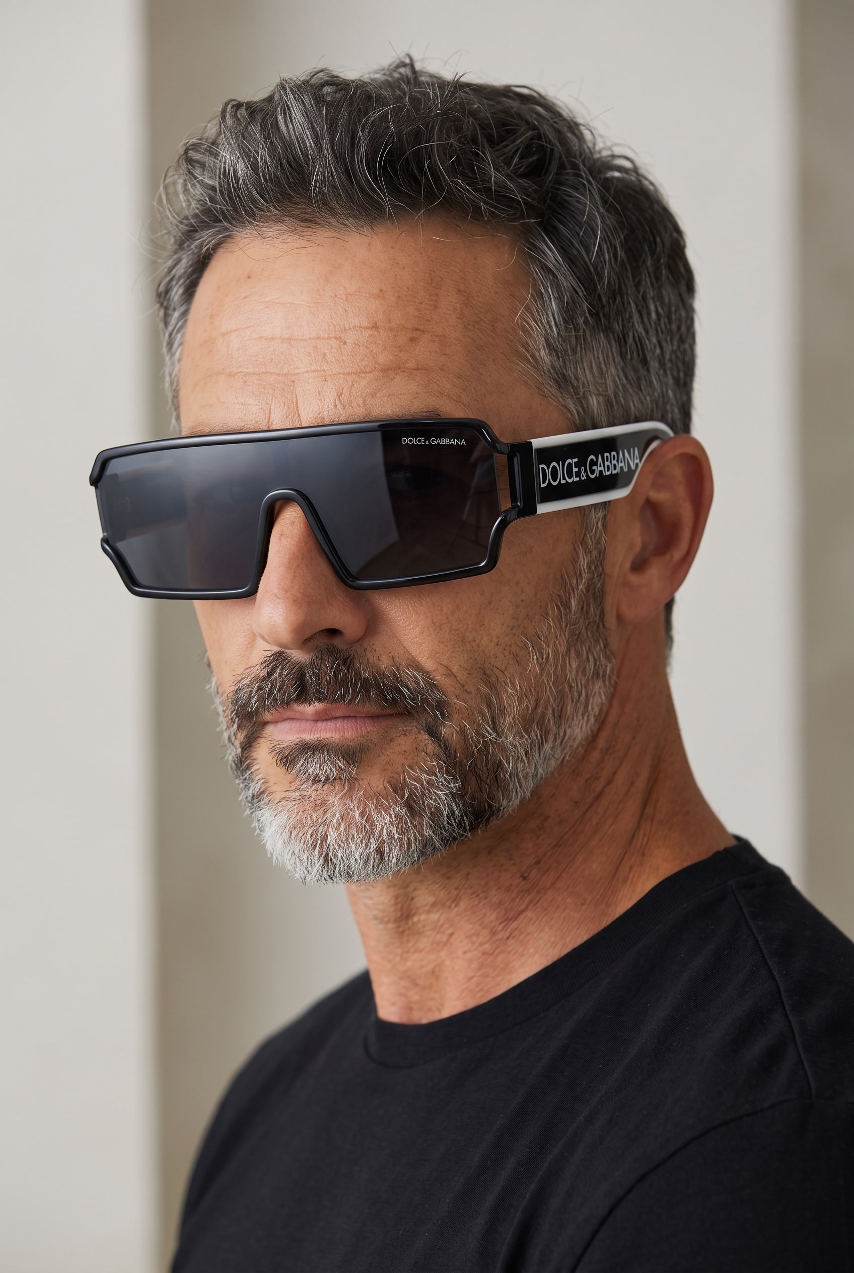 Dolce & Gabbana black shield sunglasses with white temple logo on male model