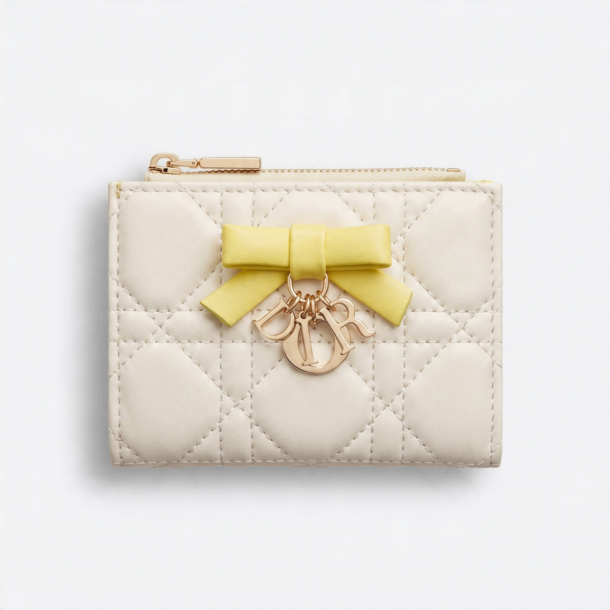 Cream quilted small wallet with yellow bow and gold letter charms and top zipper