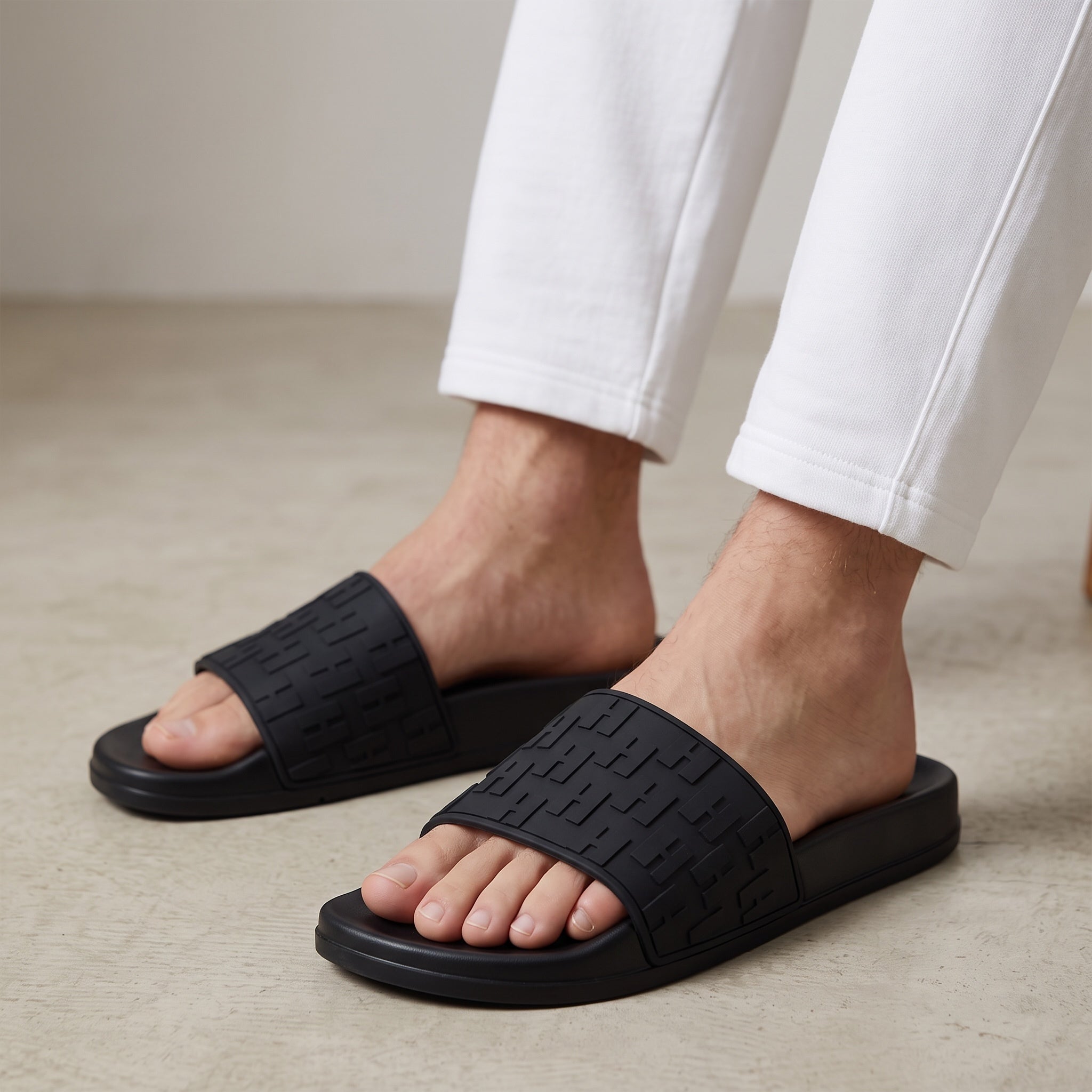 black rubber designer slide with embossed FF motif on strap