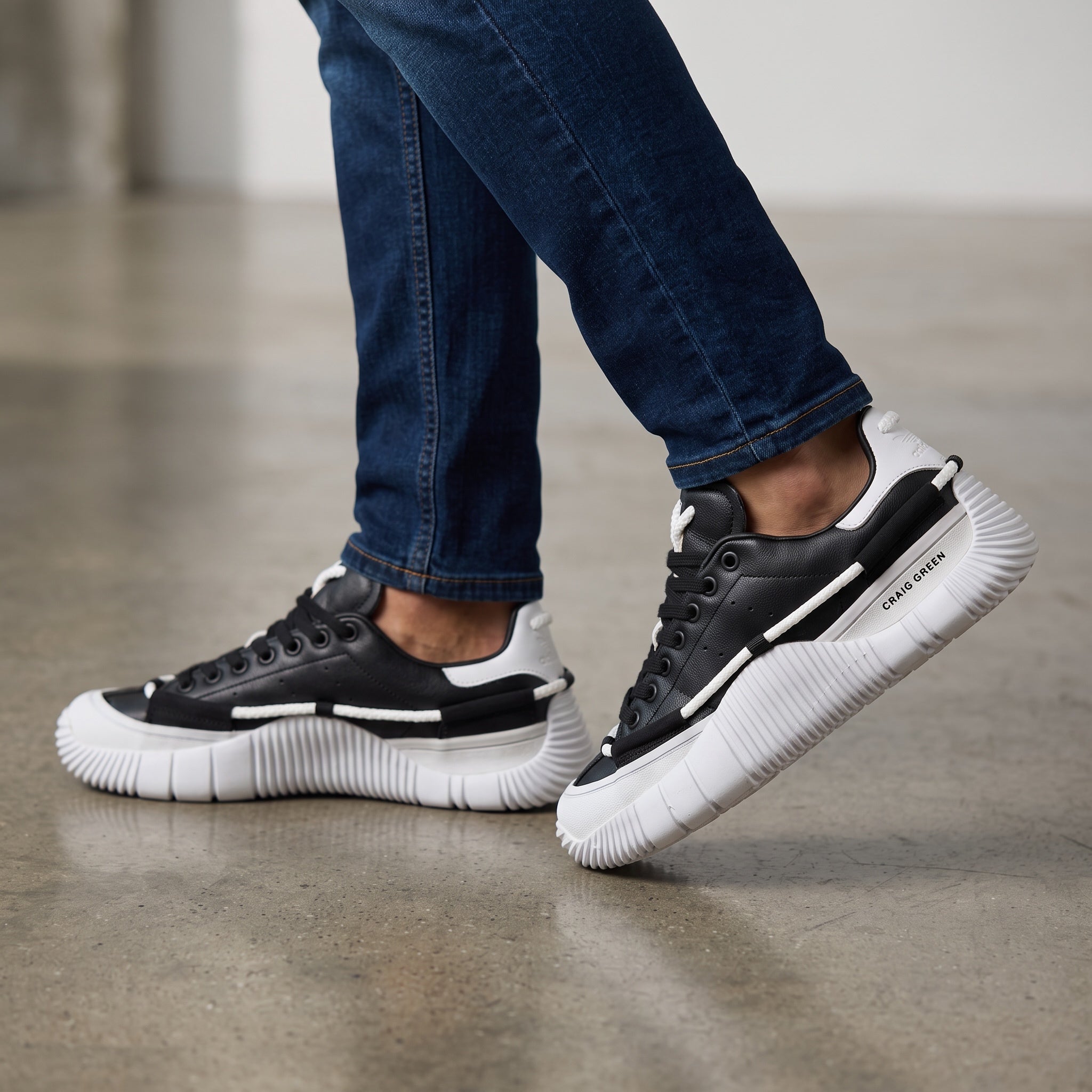 black and white Craig Green adidas low-top sneakers with rope detailing and ridged sole
