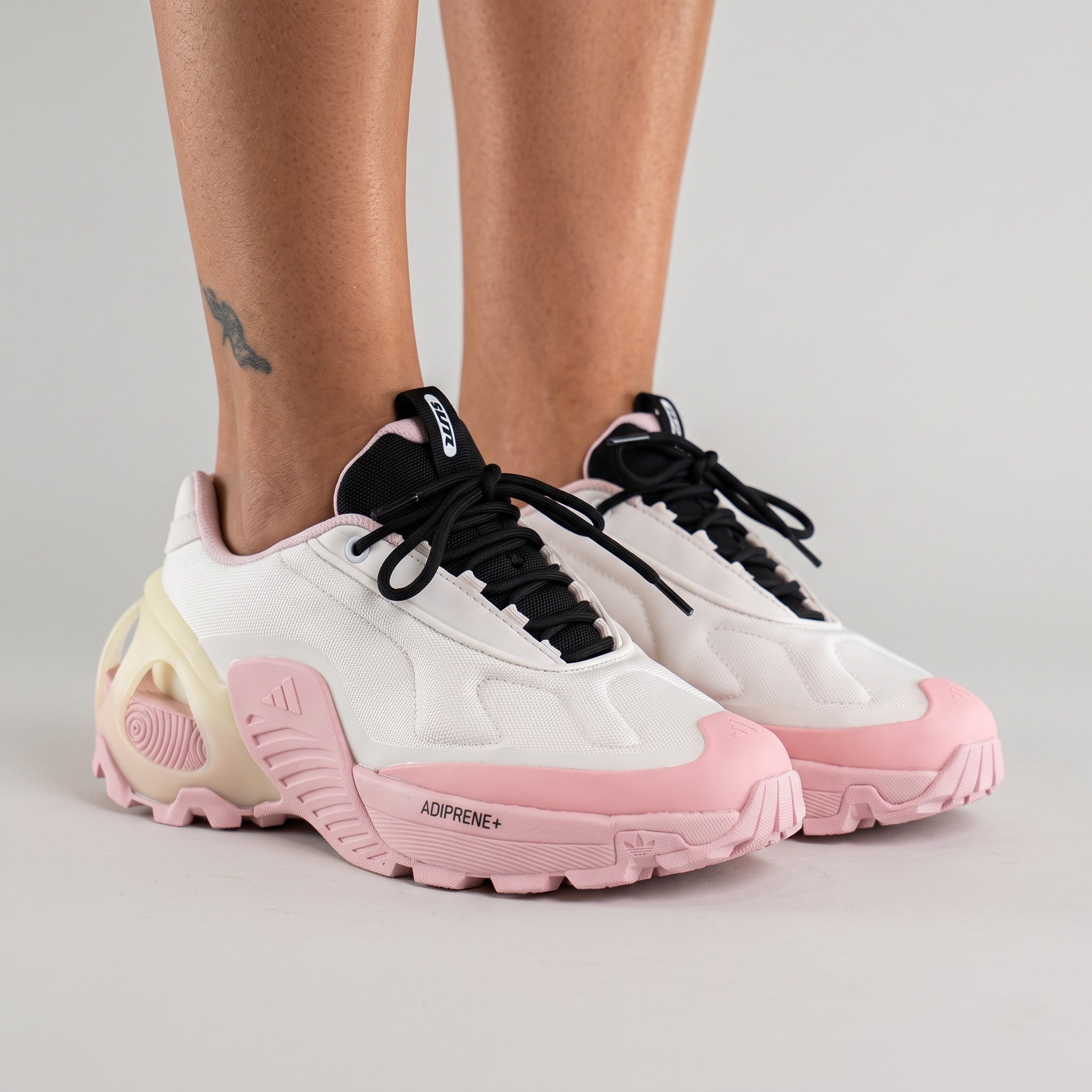 White and pink Adidas chunky platform sneaker with sculpted adiPRENE+ sole and black tongue