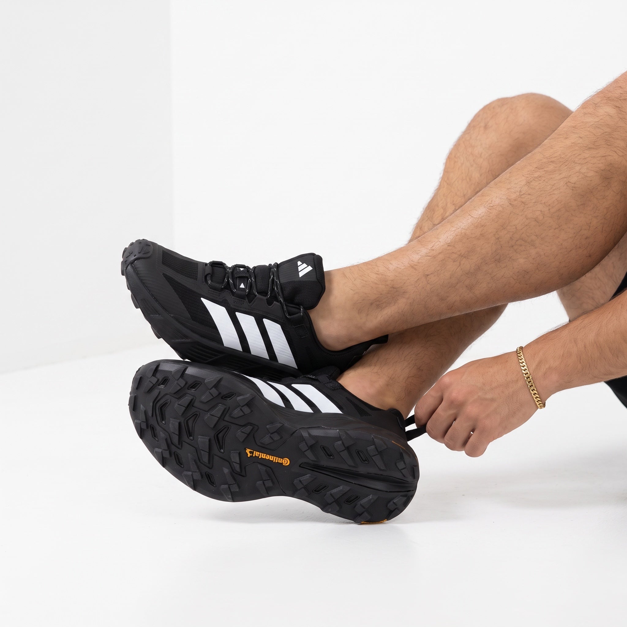 black adidas terrex trail running shoe with white three stripes and rugged outsole