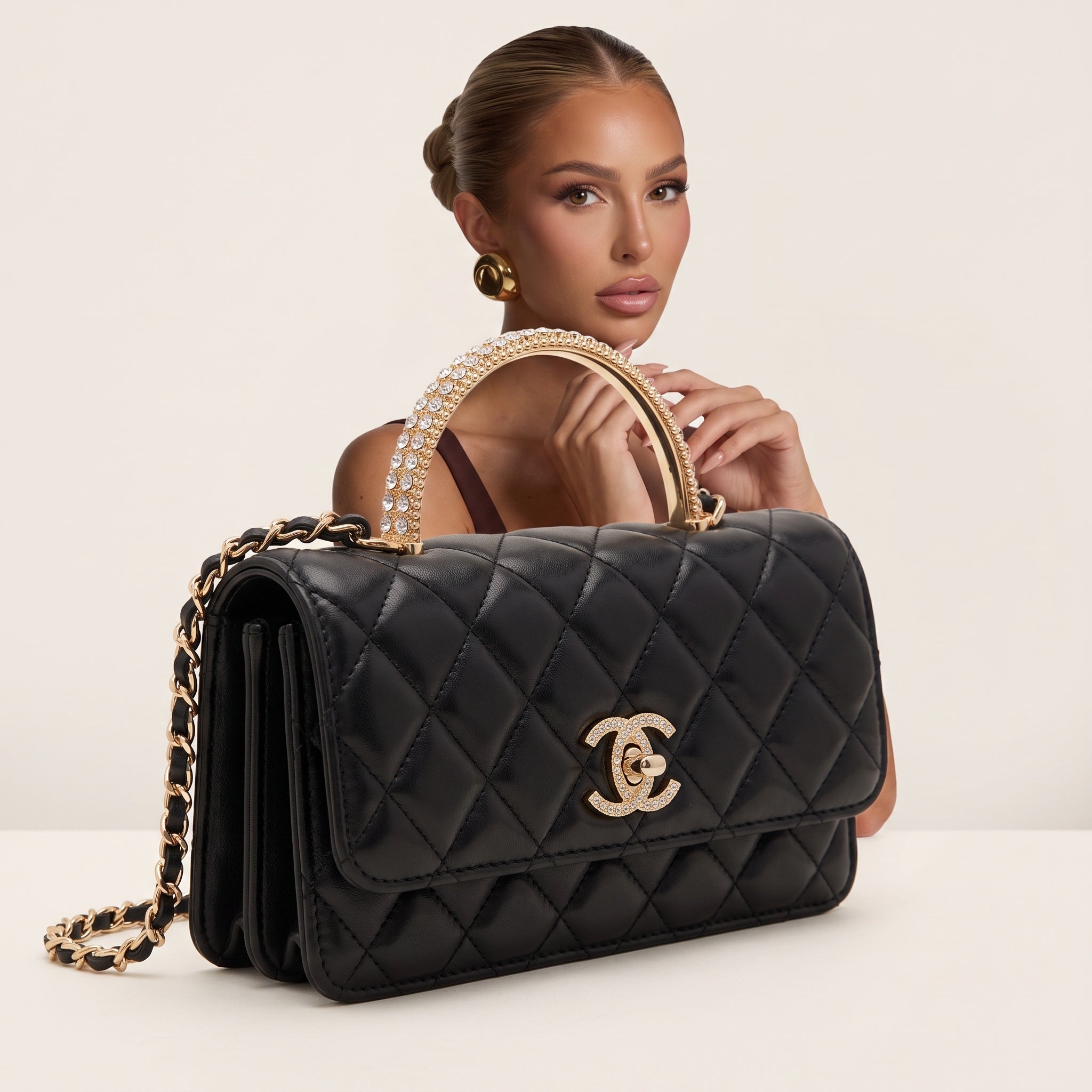 black quilted Chanel flap bag with gold chain strap and crystal top handle