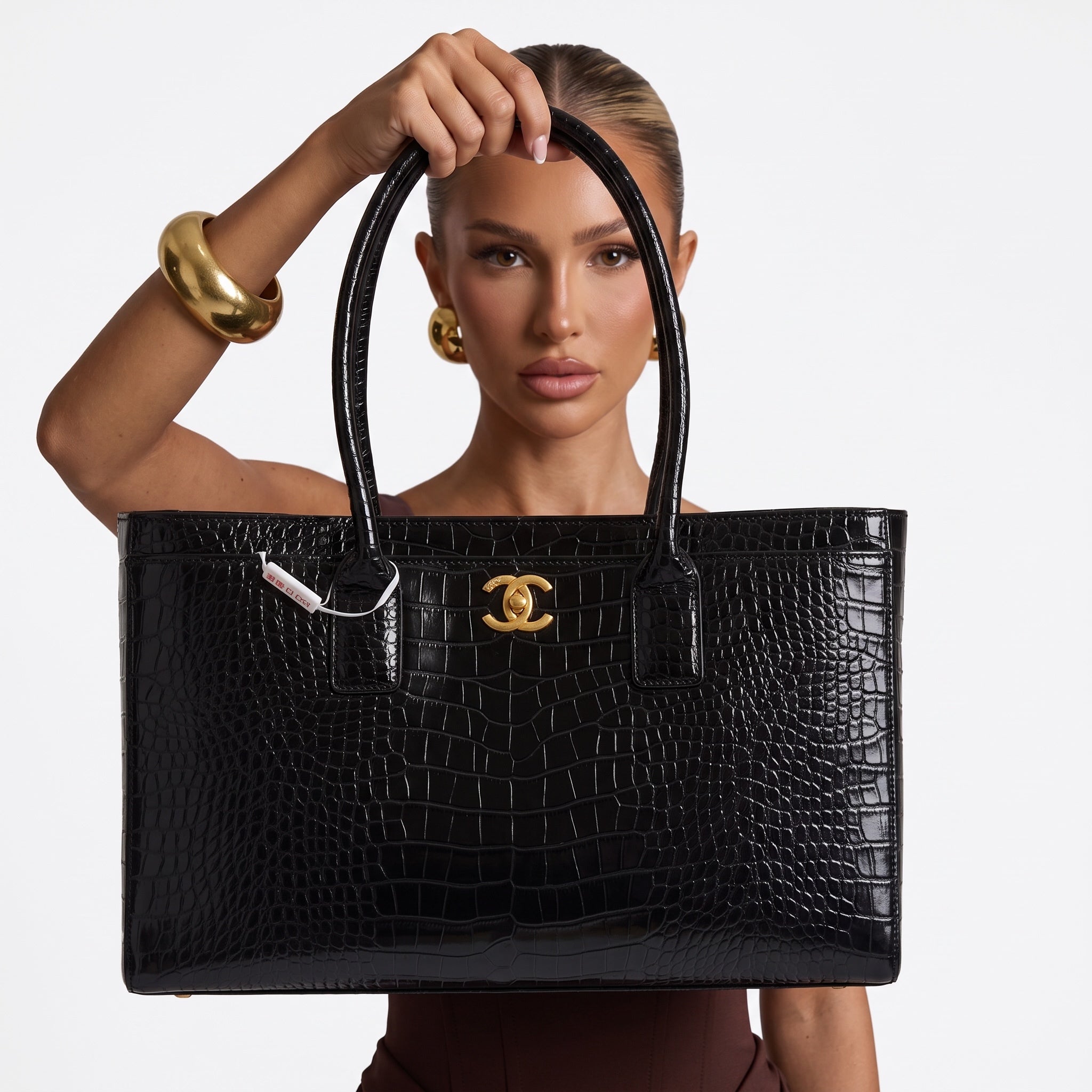 Black croc-embossed Chanel tote with gold CC hardware and rolled top handles