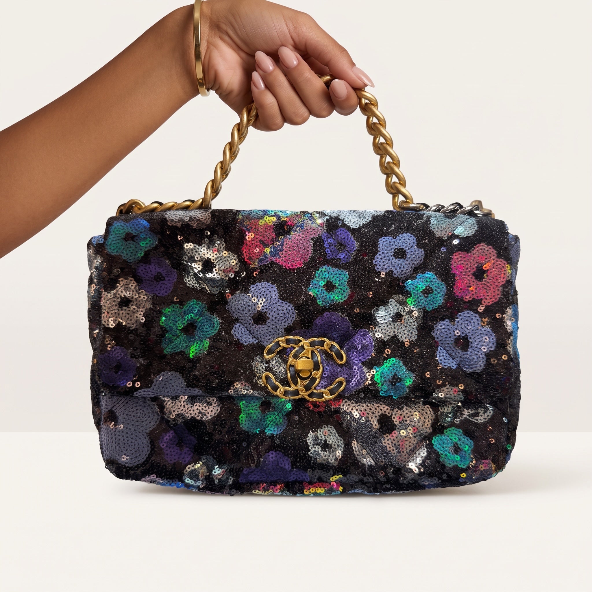 Chanel black sequin floral flap bag with gold CC logo and mixed-metal chain handle