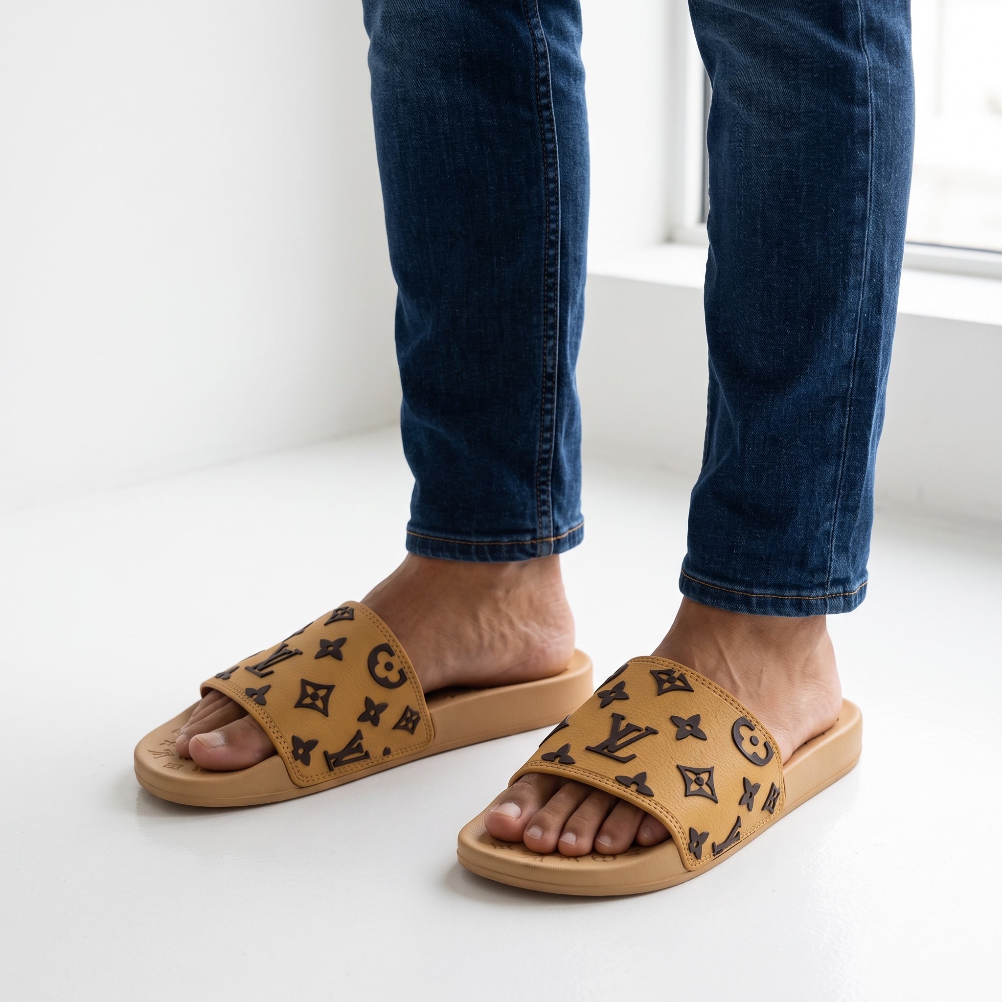 tan monogram slides with raised LV logos