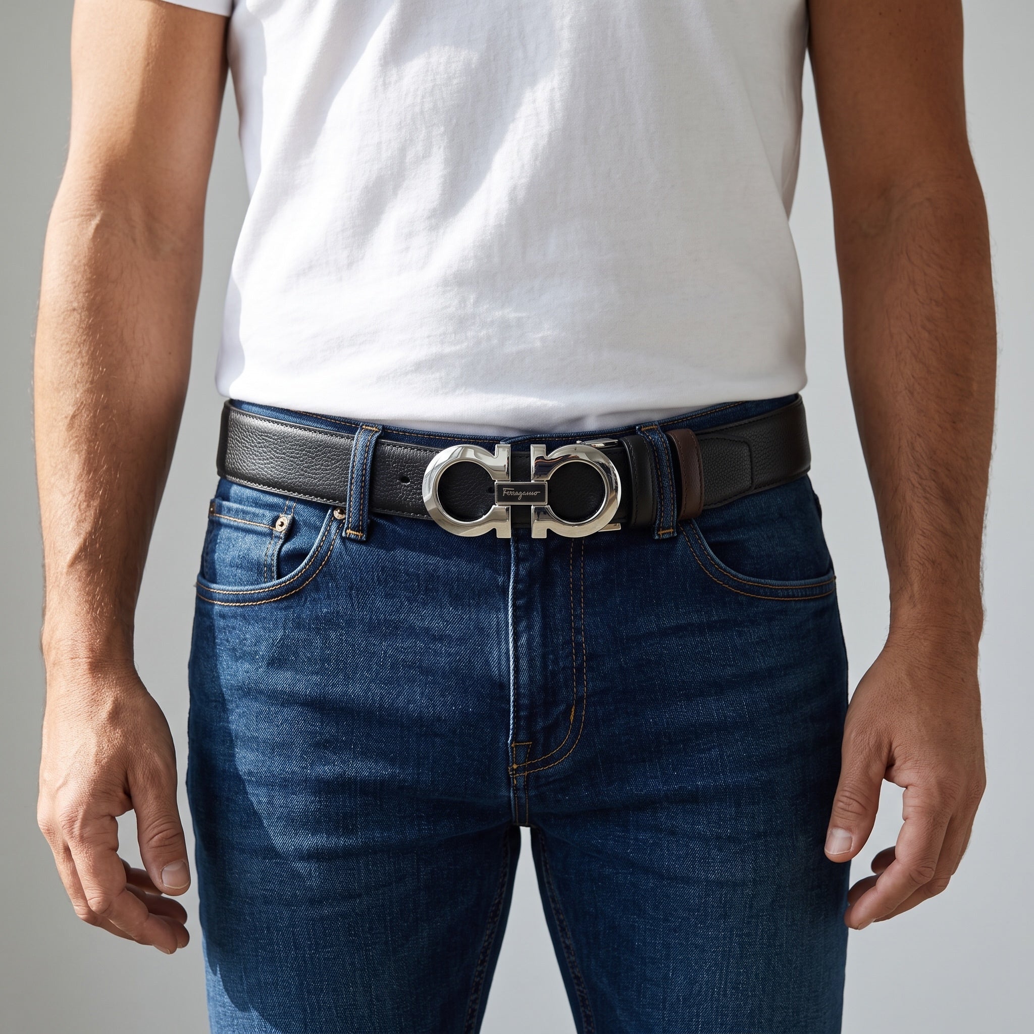 Ferragamo black belt with silver double Gancini buckle worn with jeans