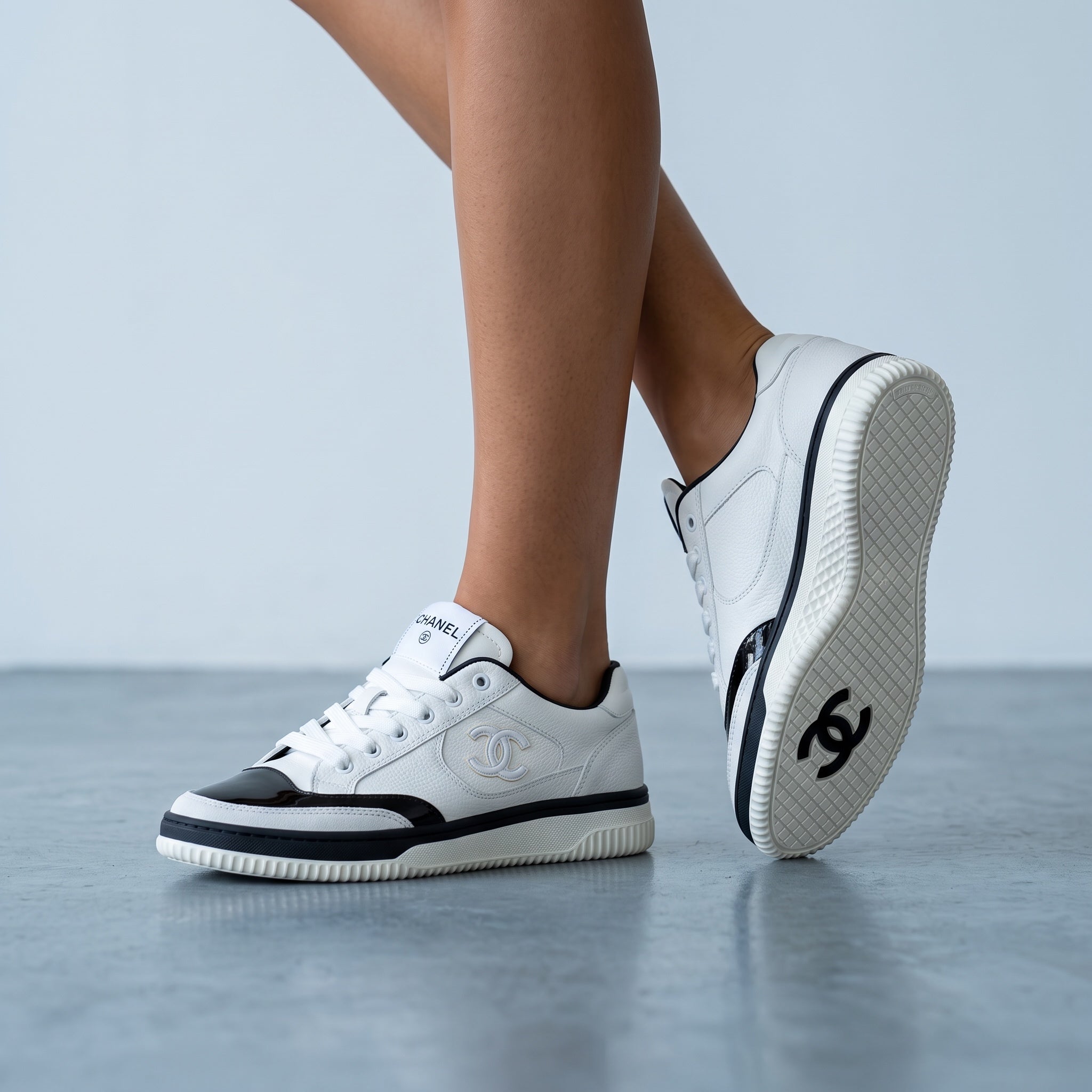 white and black Chanel low-top sneakers with CC logo