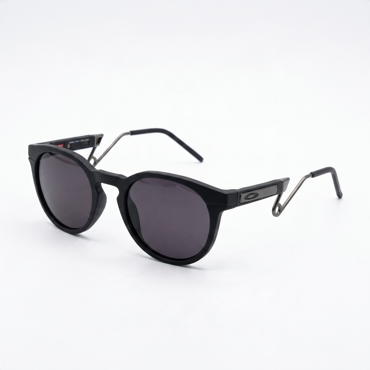Oakley matte black round sunglasses with dark lenses and metal temples