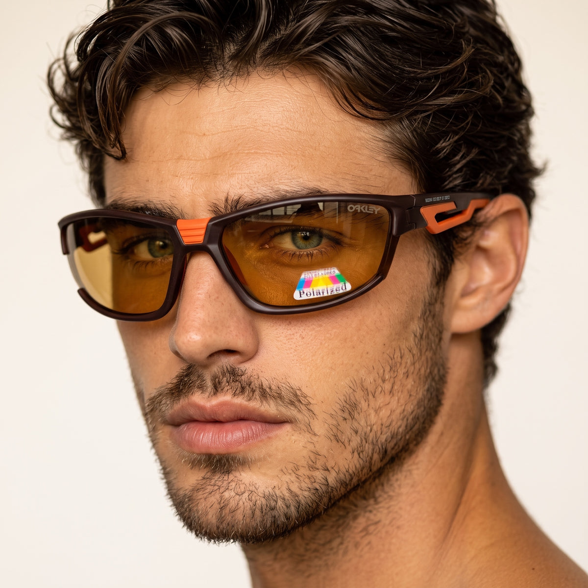 Oakley brown wrap sunglasses with orange accents and amber polarized lenses on male model