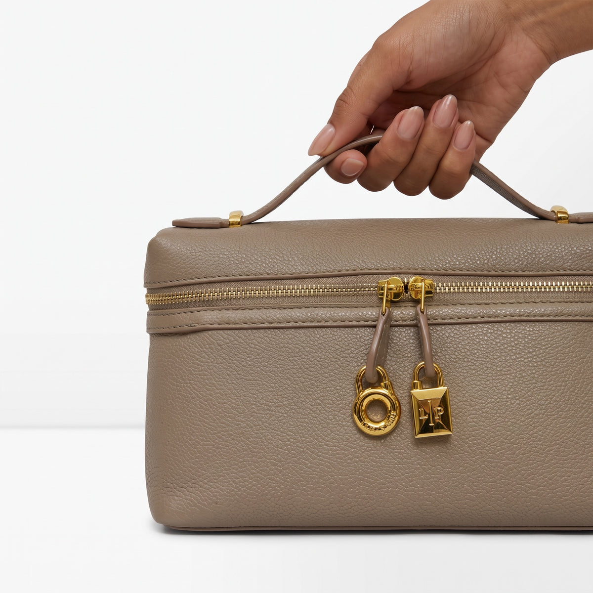 taupe top-handle bag with gold hardware and LP charm