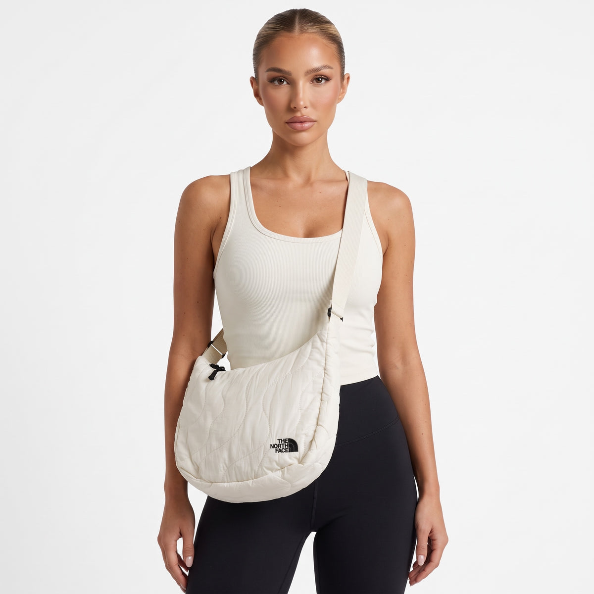 Ivory quilted The North Face crossbody bag with adjustable strap