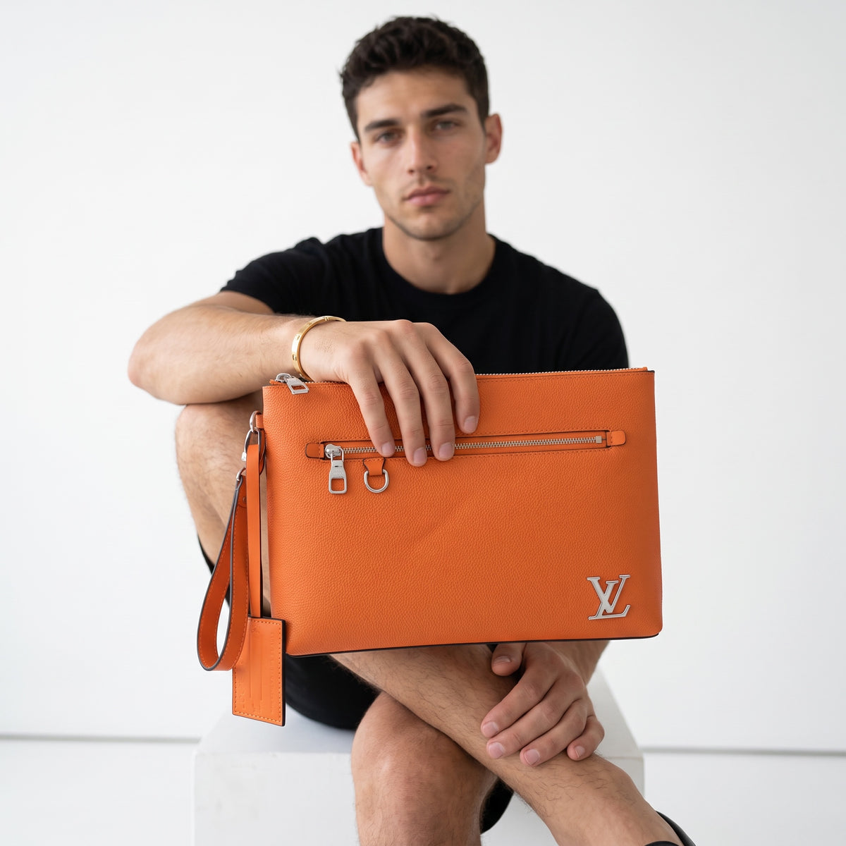 orange Louis Vuitton leather pouch with LV logo and front zip pocket