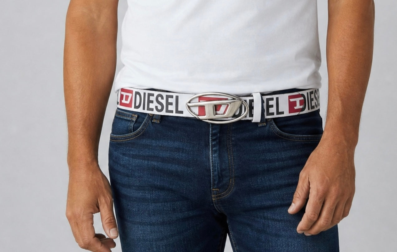 White Diesel belt with repeating logo and oval metal buckle worn with jeans