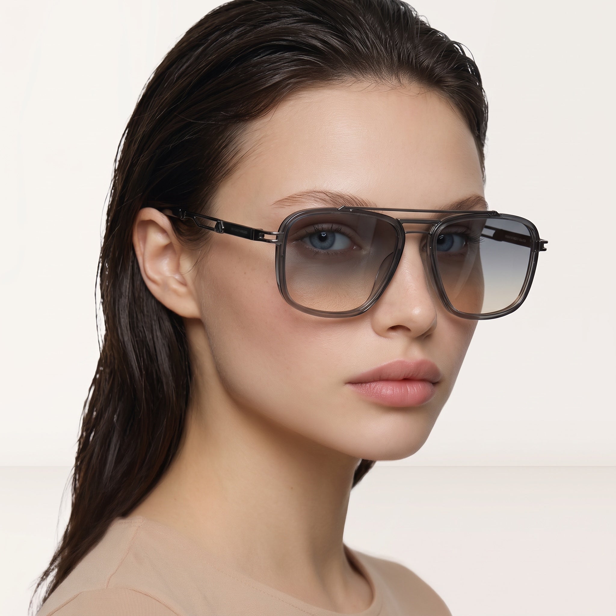 Close-up of model wearing Saint Laurent aviator grey gradient sunglasses