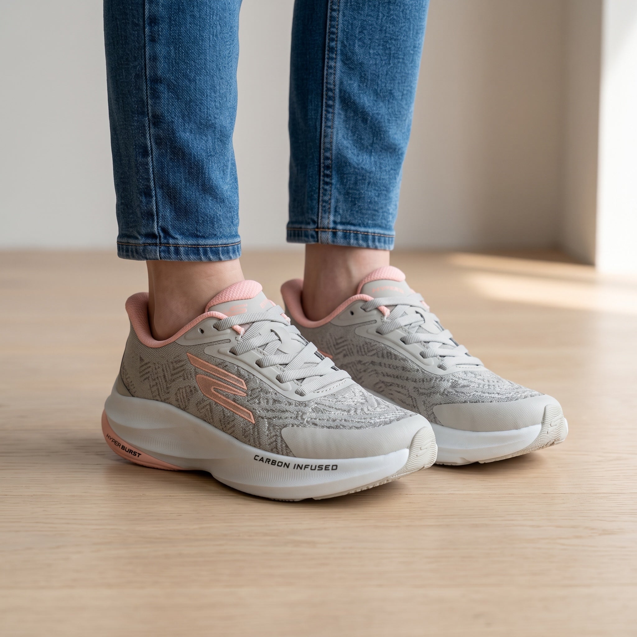 light grey Skechers lace-up sneakers with pink accents and thick white midsole