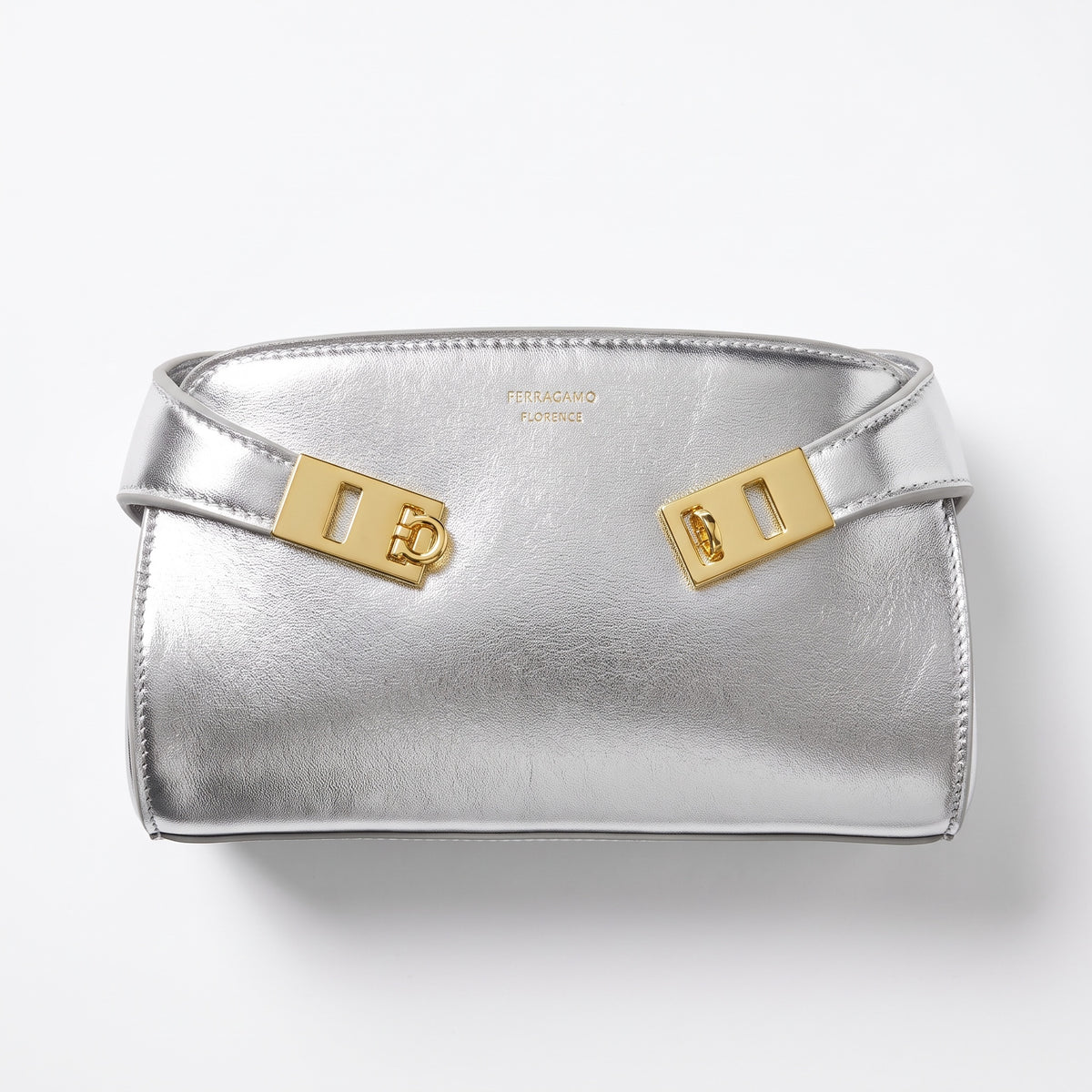 Silver Ferragamo mini bag with gold Gancini hardware and metallic finish