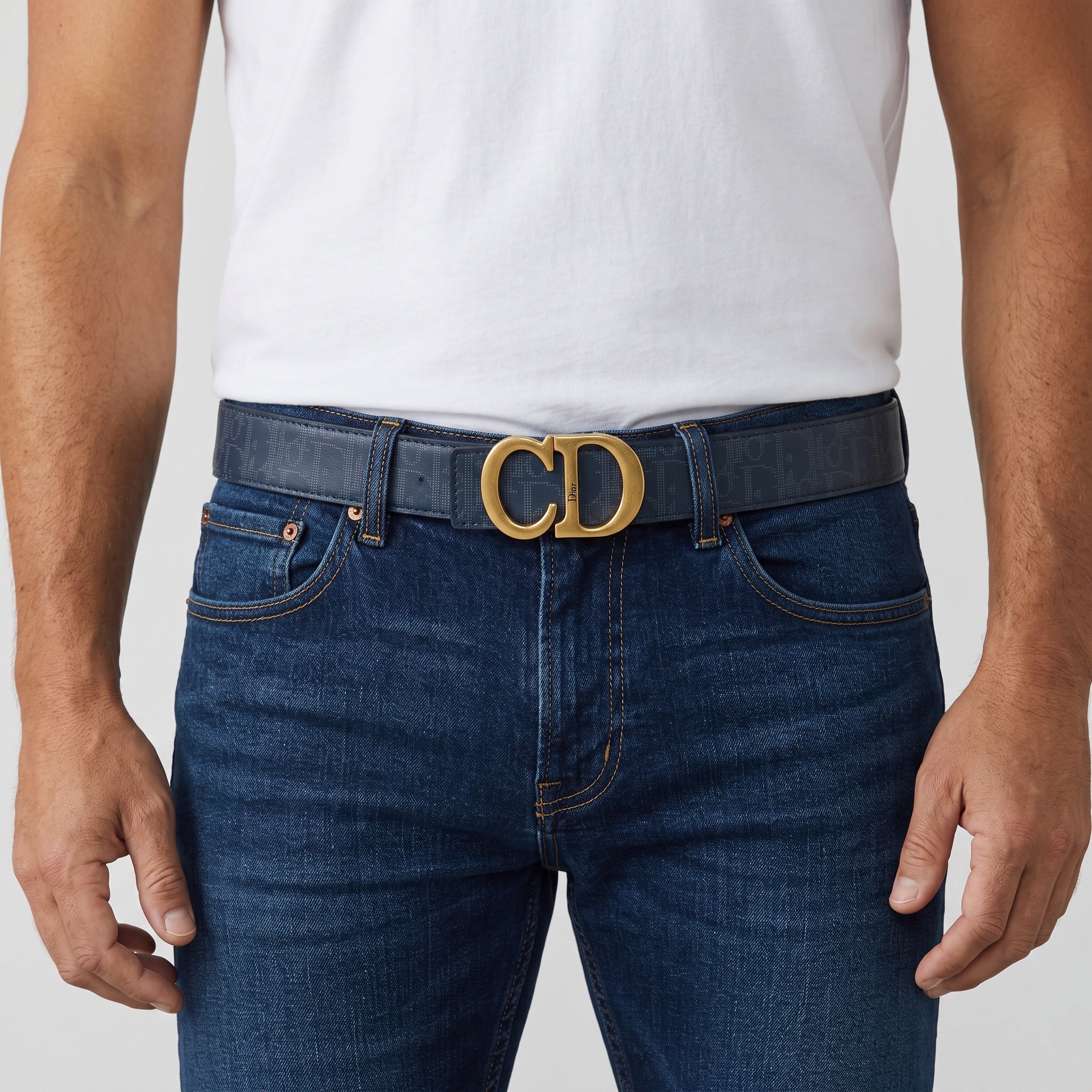 Dior navy monogram belt with gold CD buckle worn with jeans