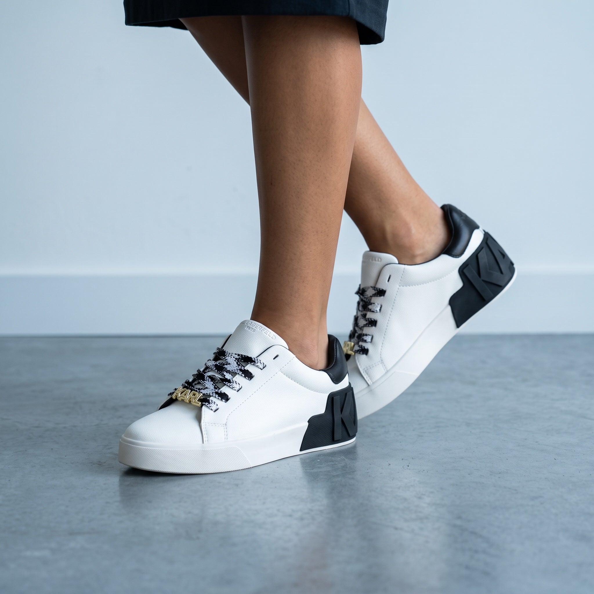 white Karl Lagerfeld low-top sneakers with black heel and KARL logo