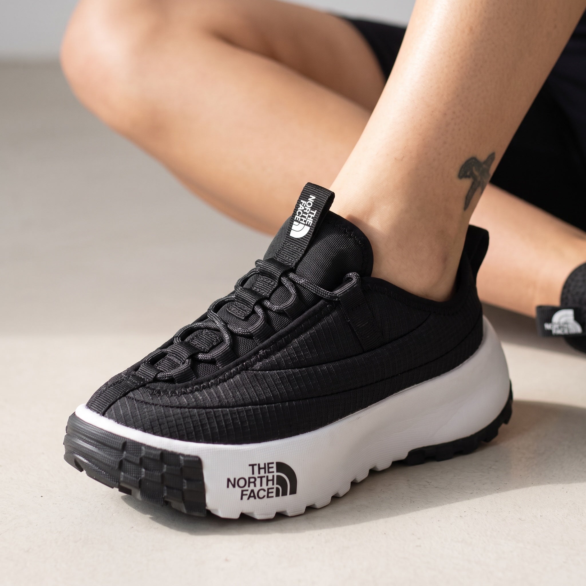 The North Face black platform trail runner with white chunky midsole and lugged outsole