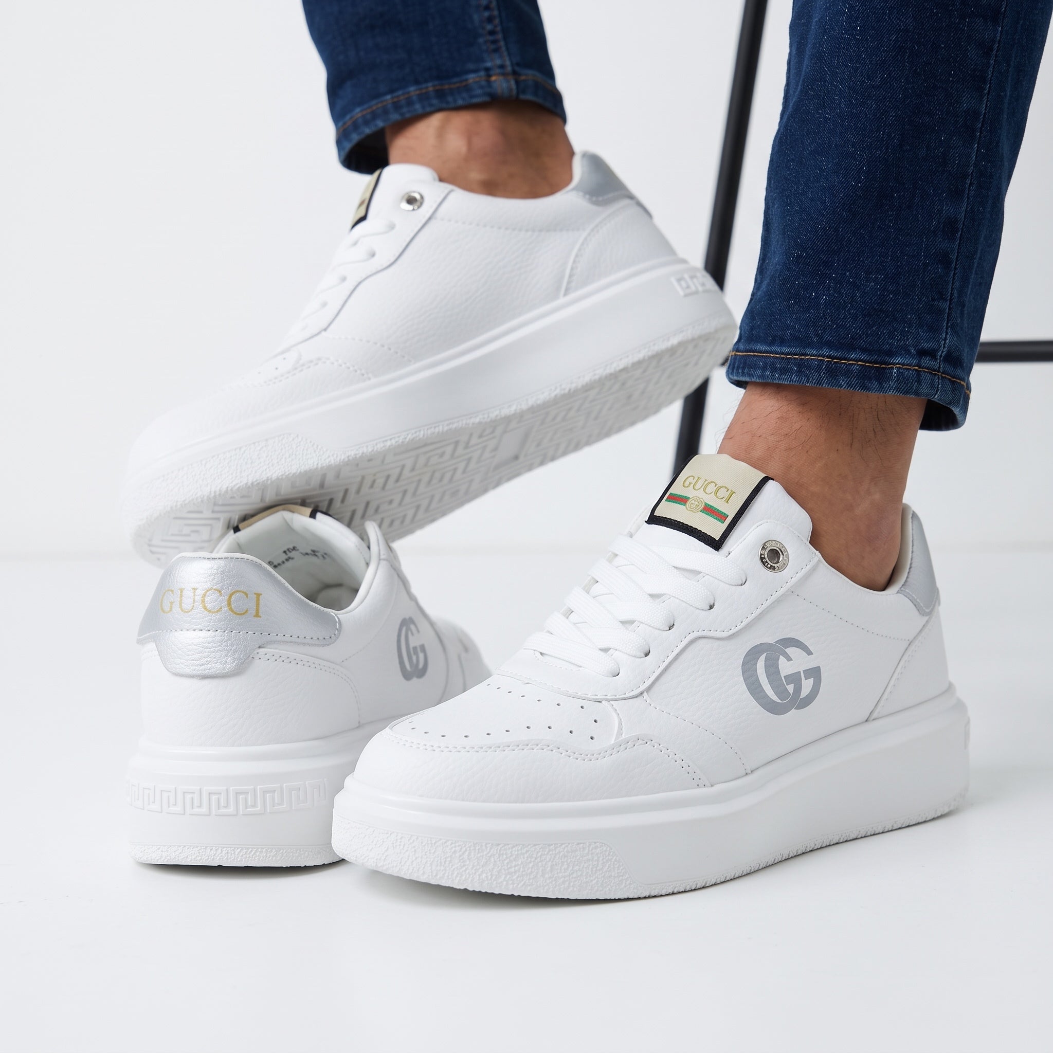White Gucci platform low-top sneakers with silver heel tab and double-G logo