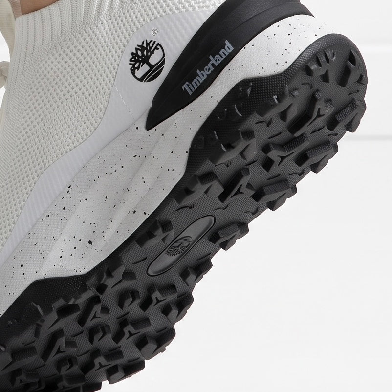 Timberland white knit slip-on sneaker with speckled midsole and black lug outsole