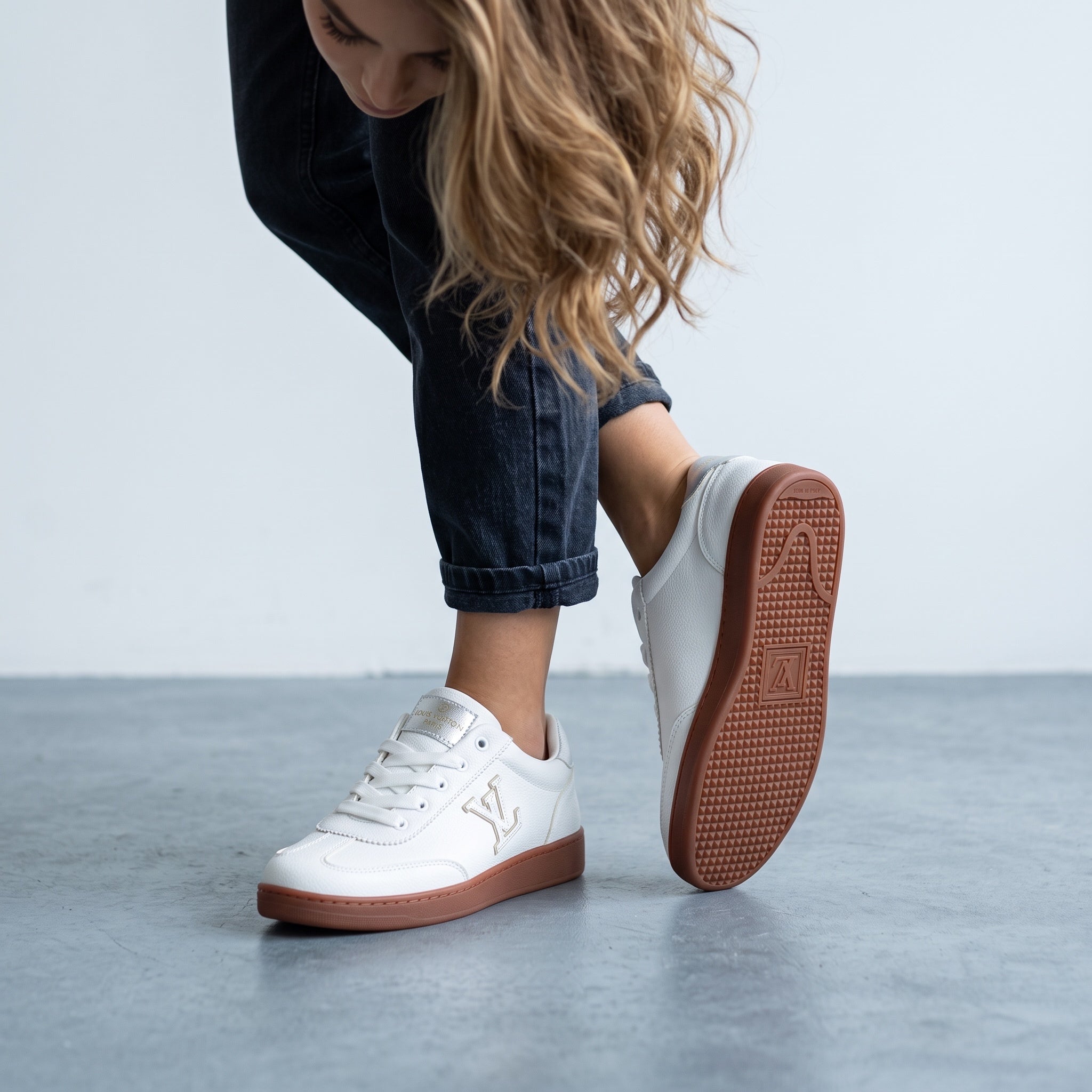 White Louis Vuitton low-top sneaker with gum sole and LV logo
