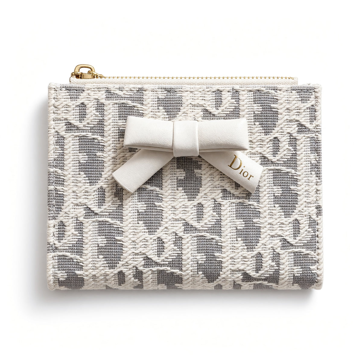Dior compact wallet with bow and patterned exterior, open showing card slots and gold zipper