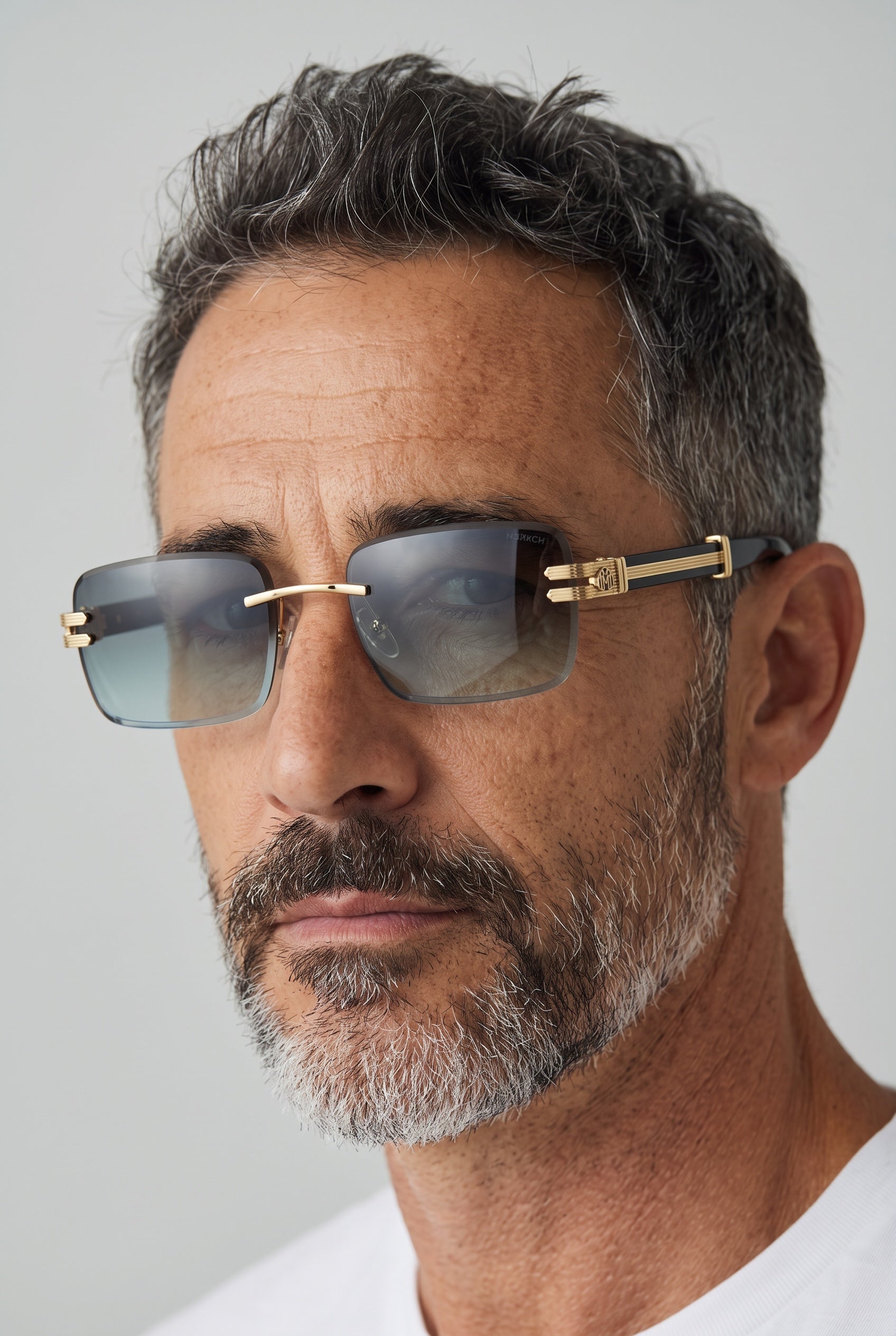 Rimless square sunglasses with gold bridge, branded gold temple plaque and smoke gradient lenses