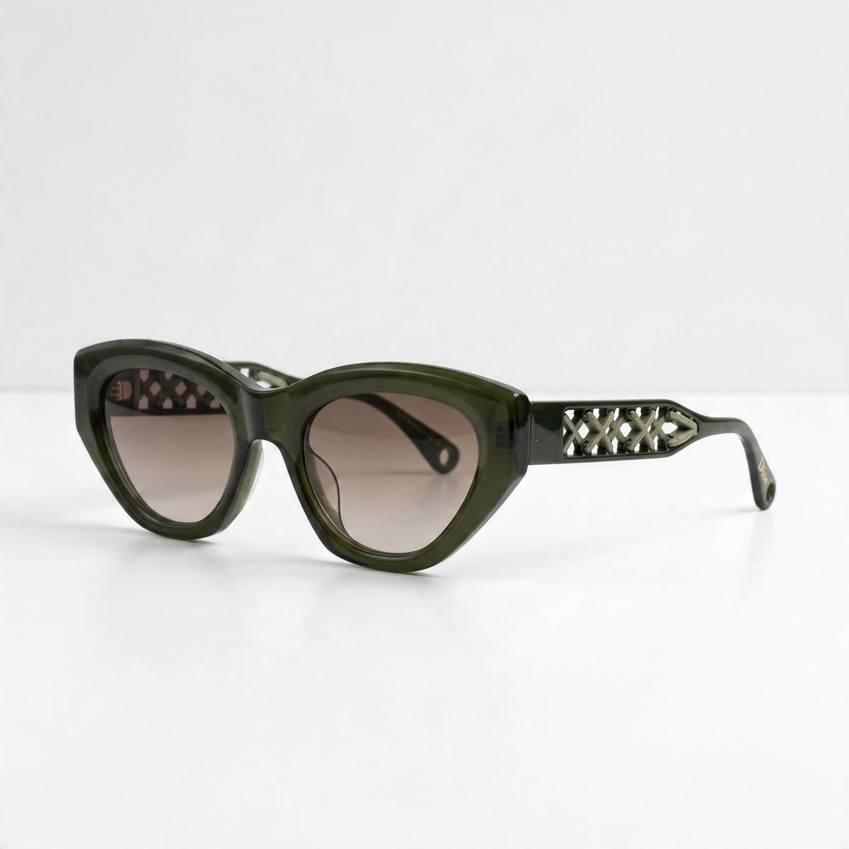 Olive green Dior cat-eye sunglasses with cutout lattice temples and gradient lenses