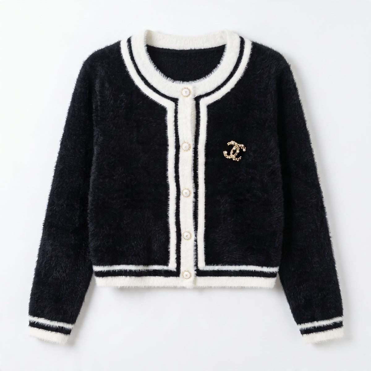 black cardigan with white trim, gold CC brooch and decorative buttons