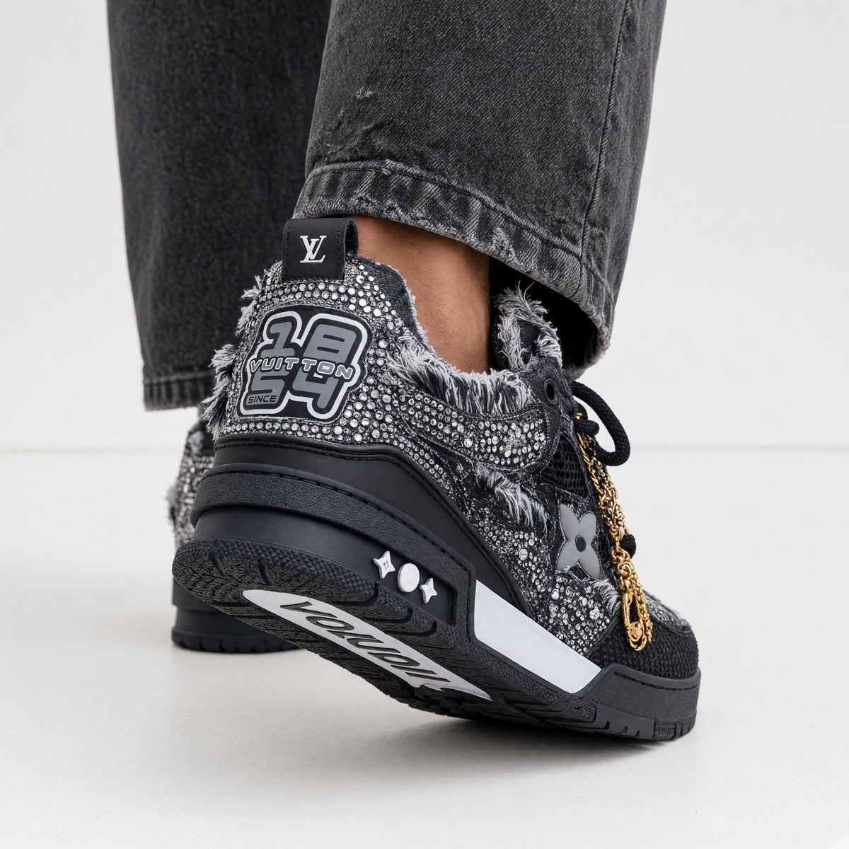 black Louis Vuitton embellished trainer with crystals and frayed trim