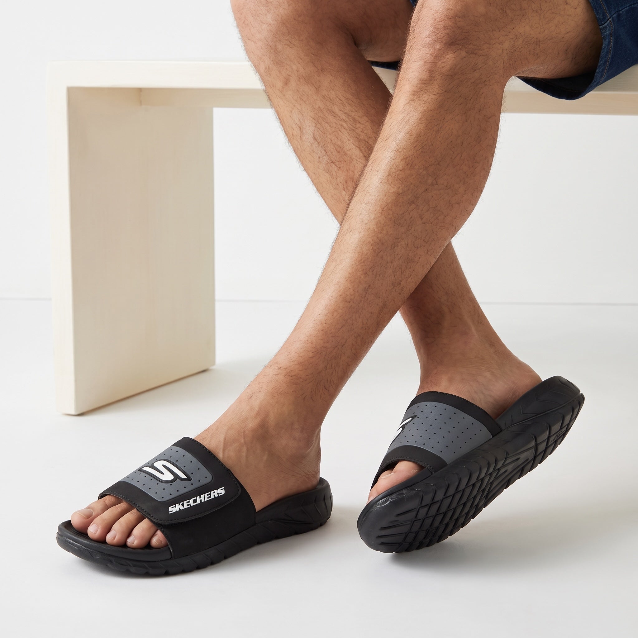 black and grey Skechers men's slide with perforated strap and logo