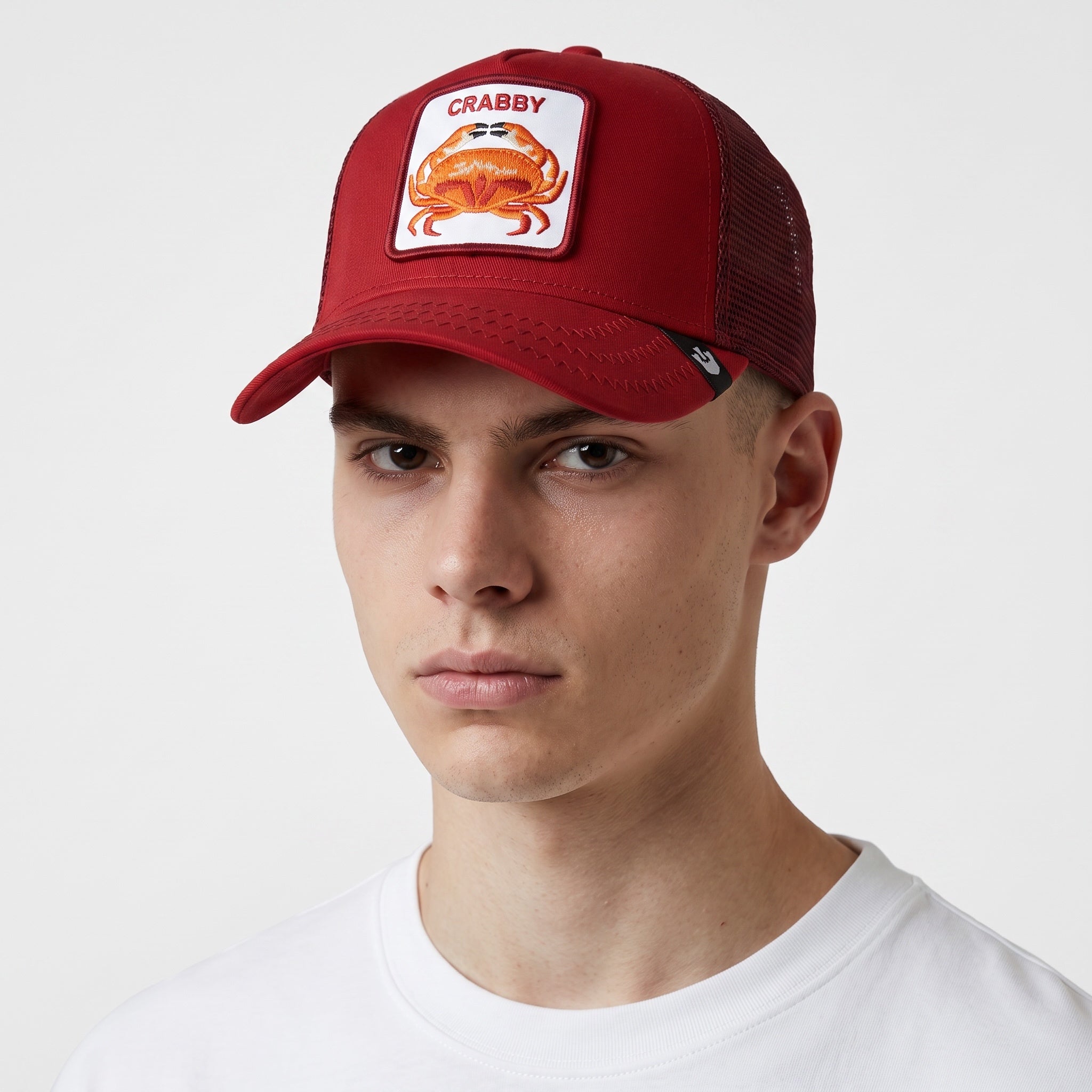 red Goorin Bros trucker cap with crab patch embroidered front