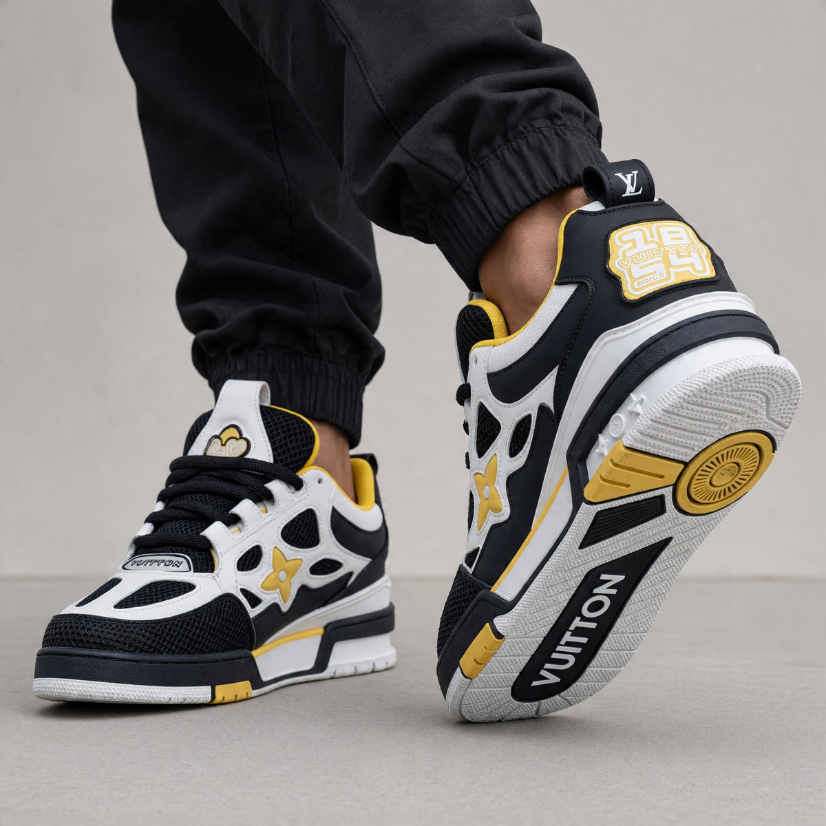 black white and yellow Louis Vuitton trainer with mesh panels and LV branding
