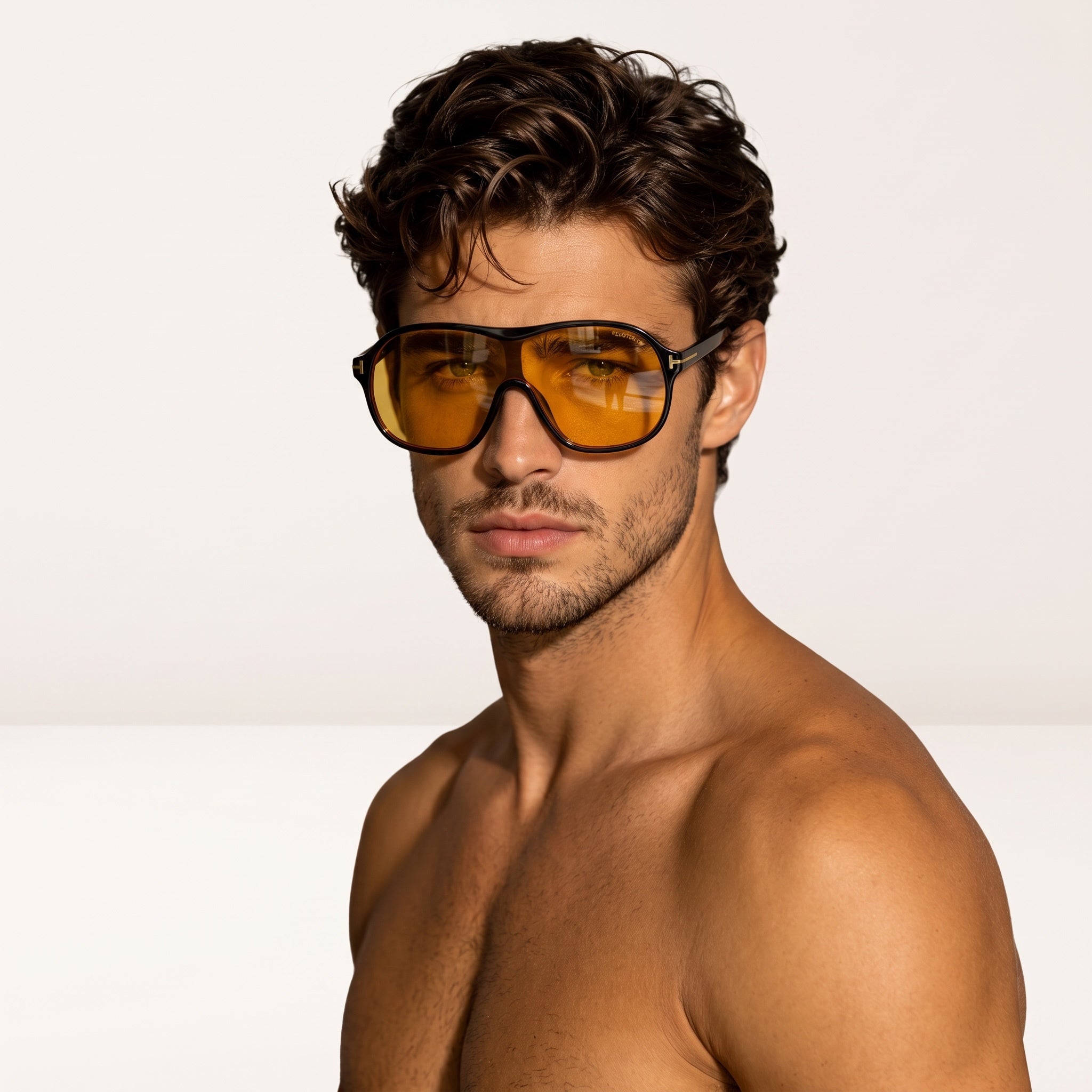 Tom Ford oversized amber shield sunglasses with gold T temples on male model