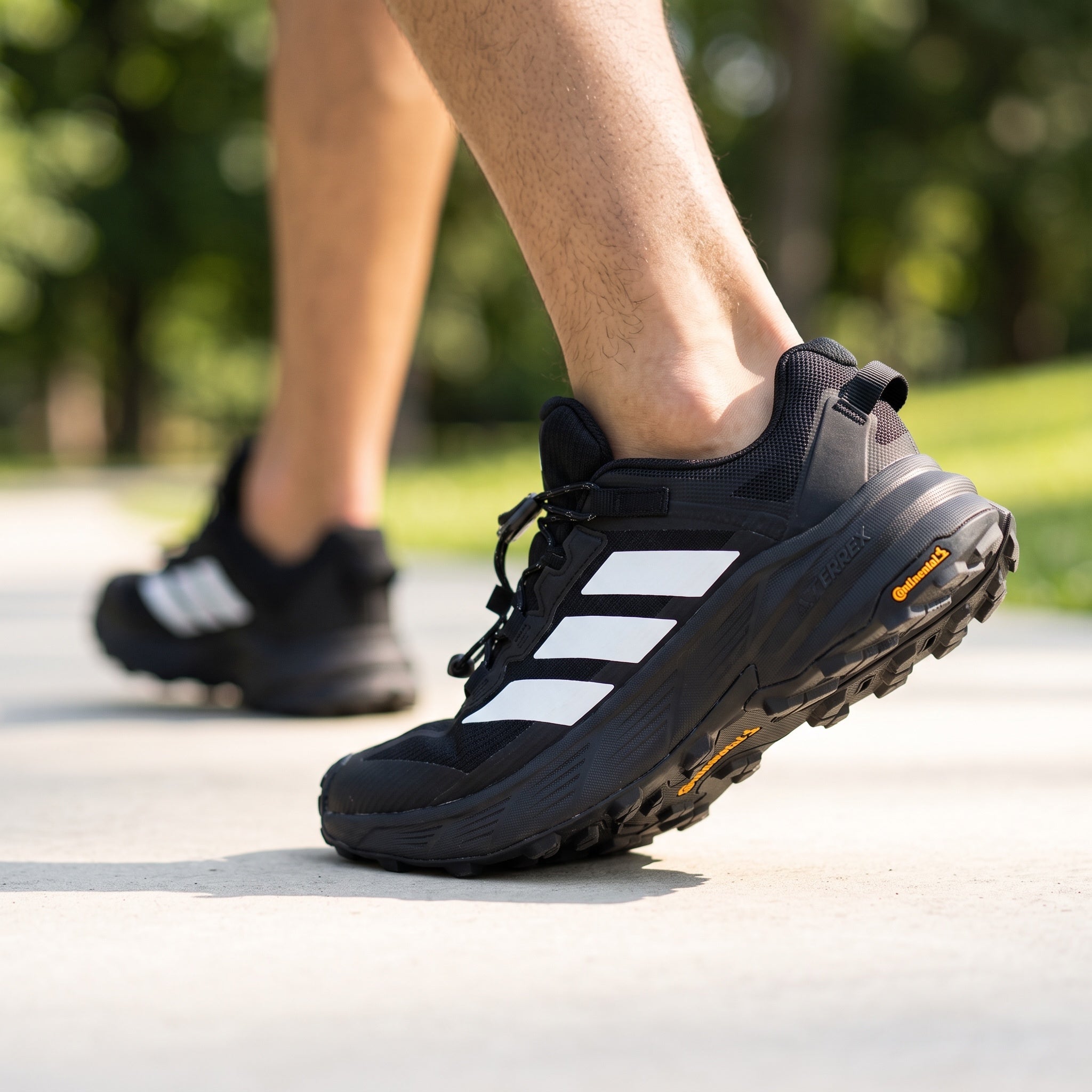 black adidas terrex trail running shoe with white three stripes and rugged outsole