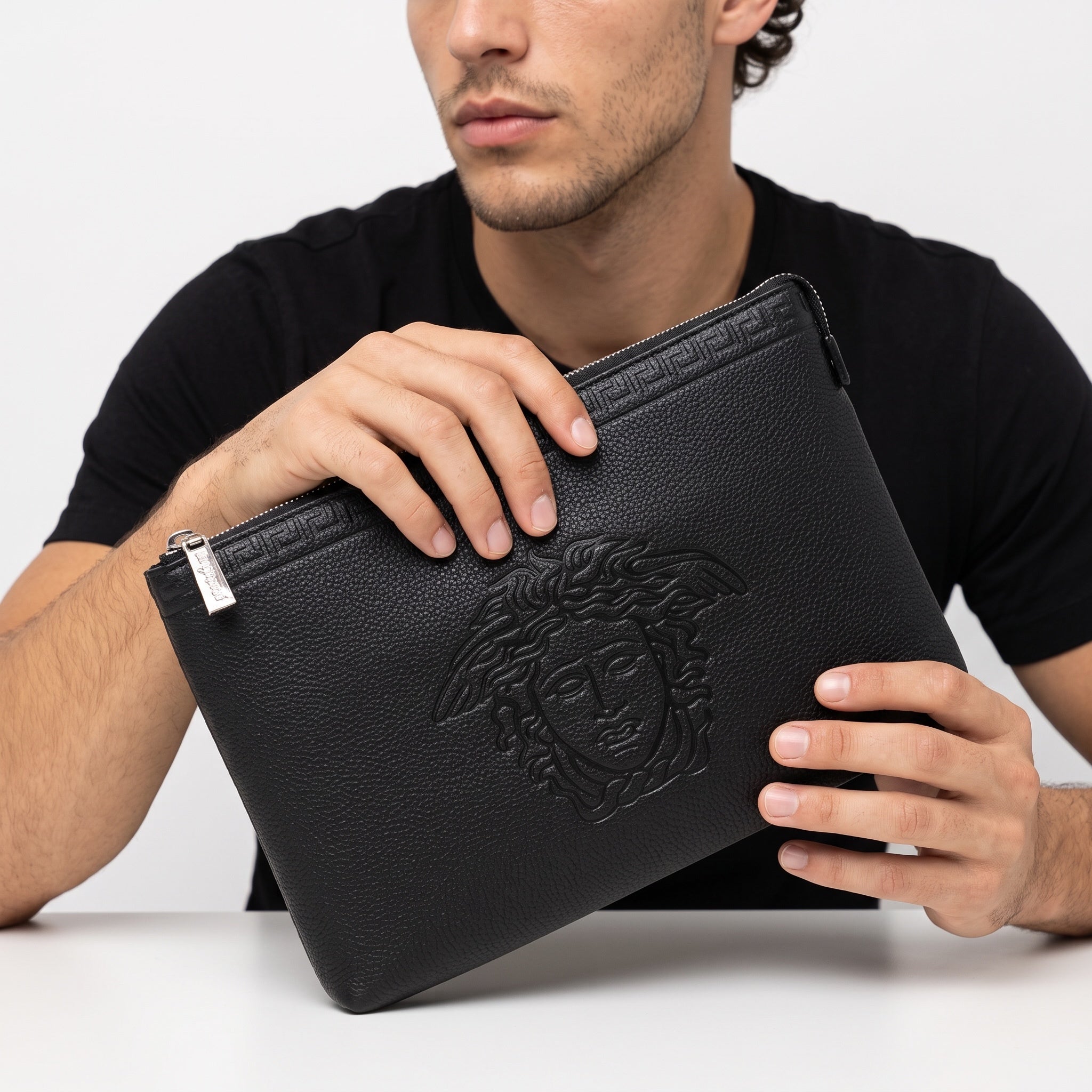 black Versace zip pouch clutch with embossed Medusa