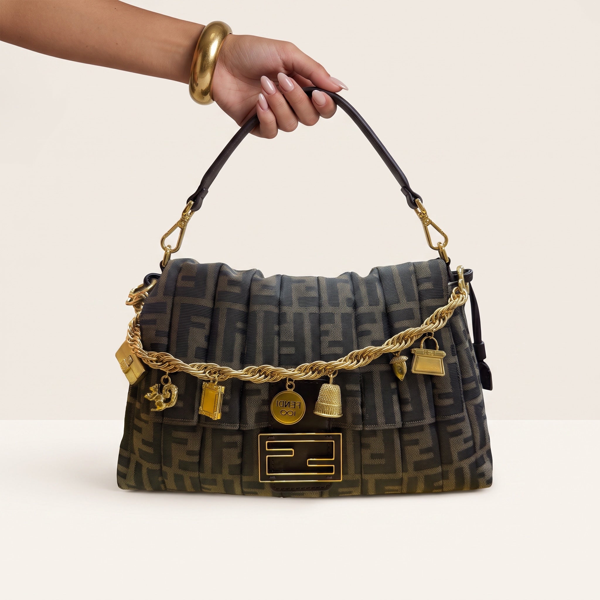Fendi baguette bag in brown Zucca monogram with gold charm chain