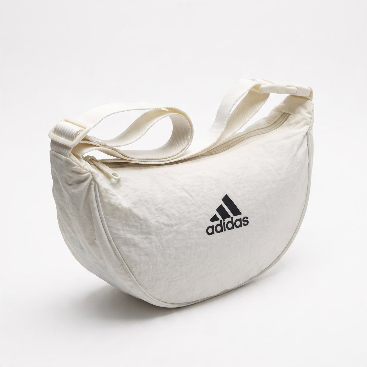 white Adidas duffel bag with adjustable strap and front logo