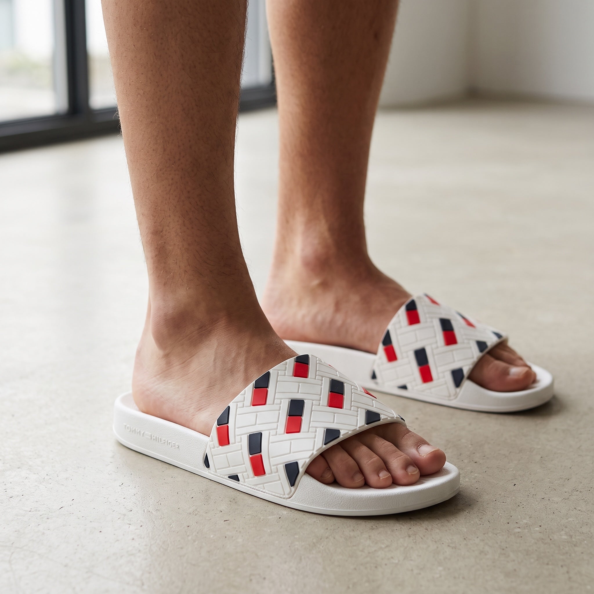 Tommy Hilfiger white slide sandals with textured geometric strap and red navy accents