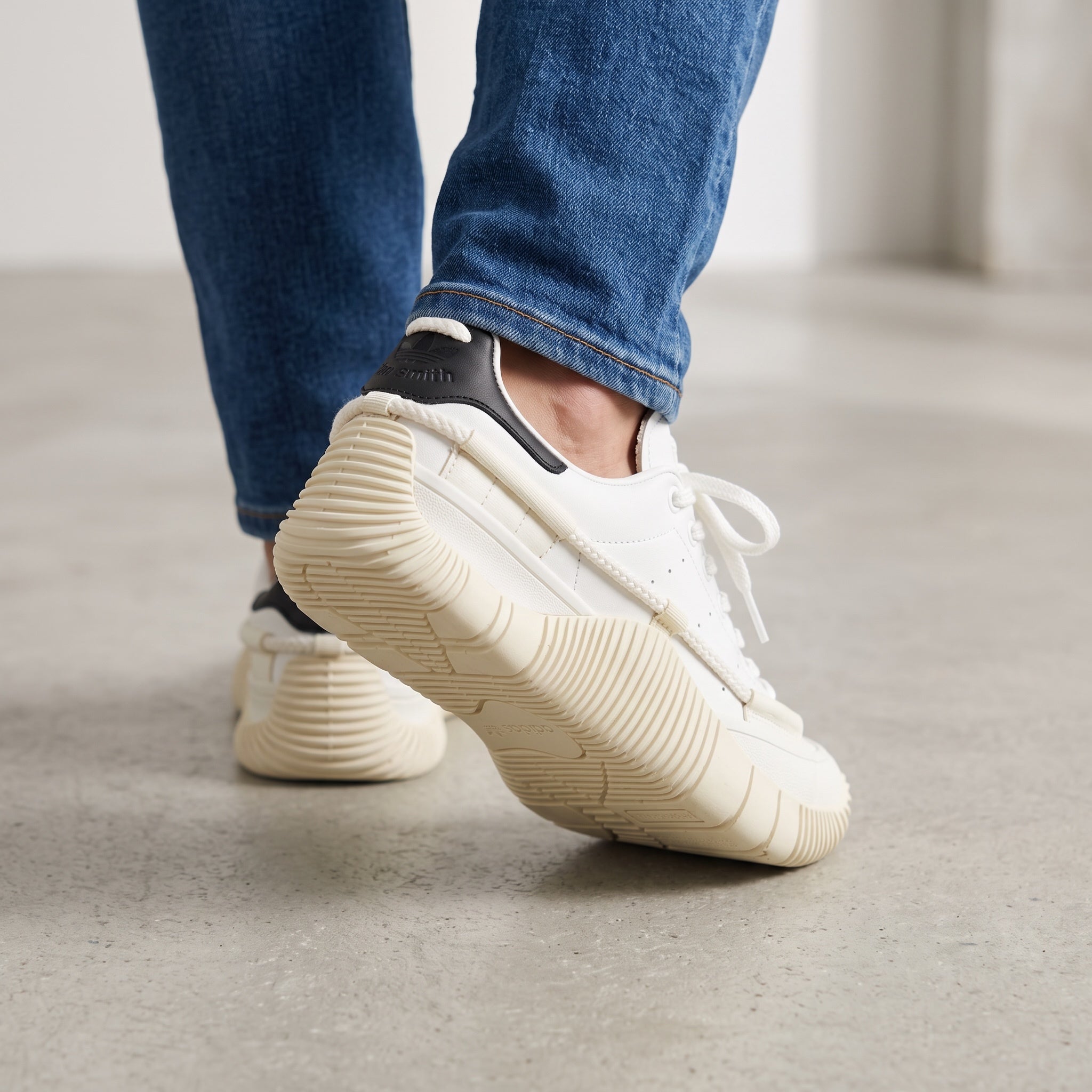 White Adidas Stan Smith low-top sneakers with cream chunky sole and black heel tab