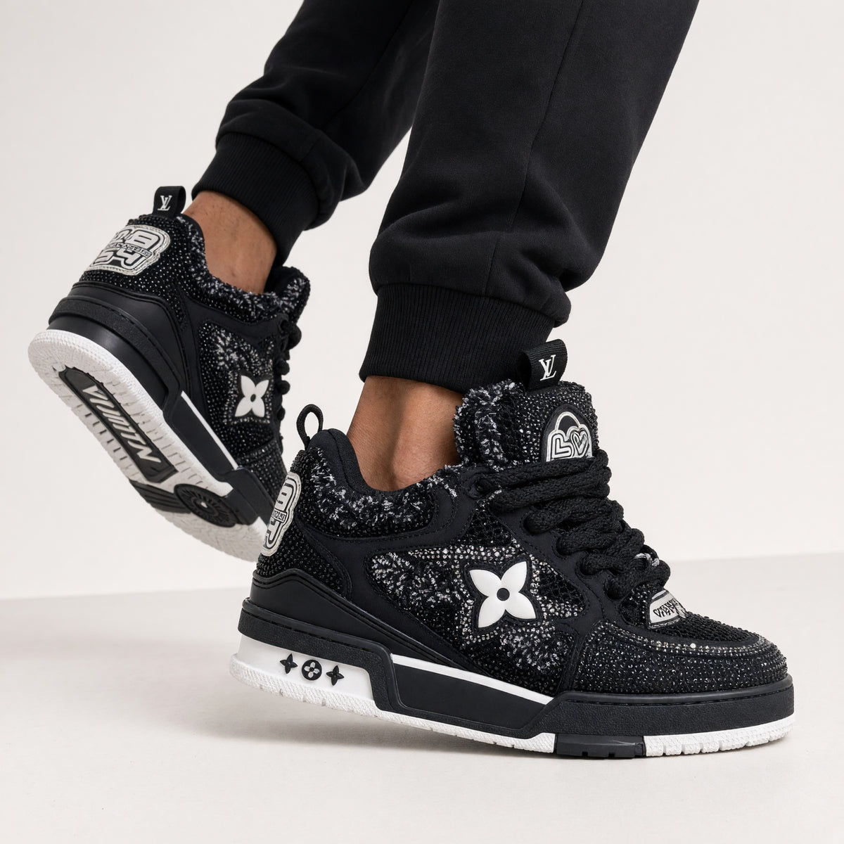pair of black Louis Vuitton trainers with textured panels and LV logo
