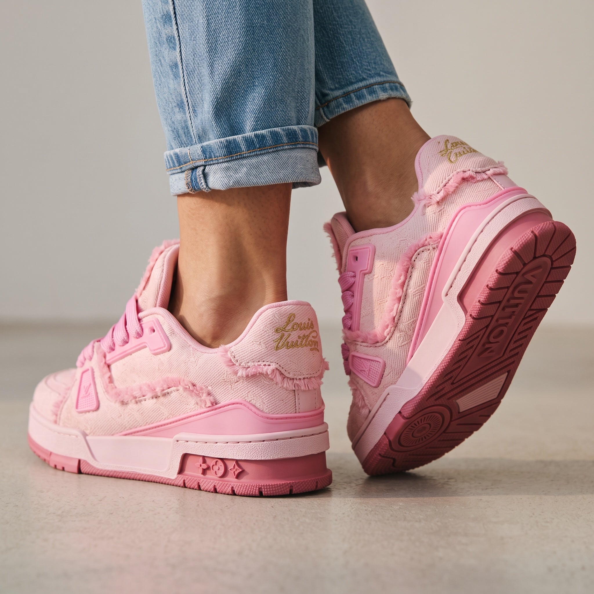 pink Louis Vuitton low-top trainers with frayed trim and LV logo