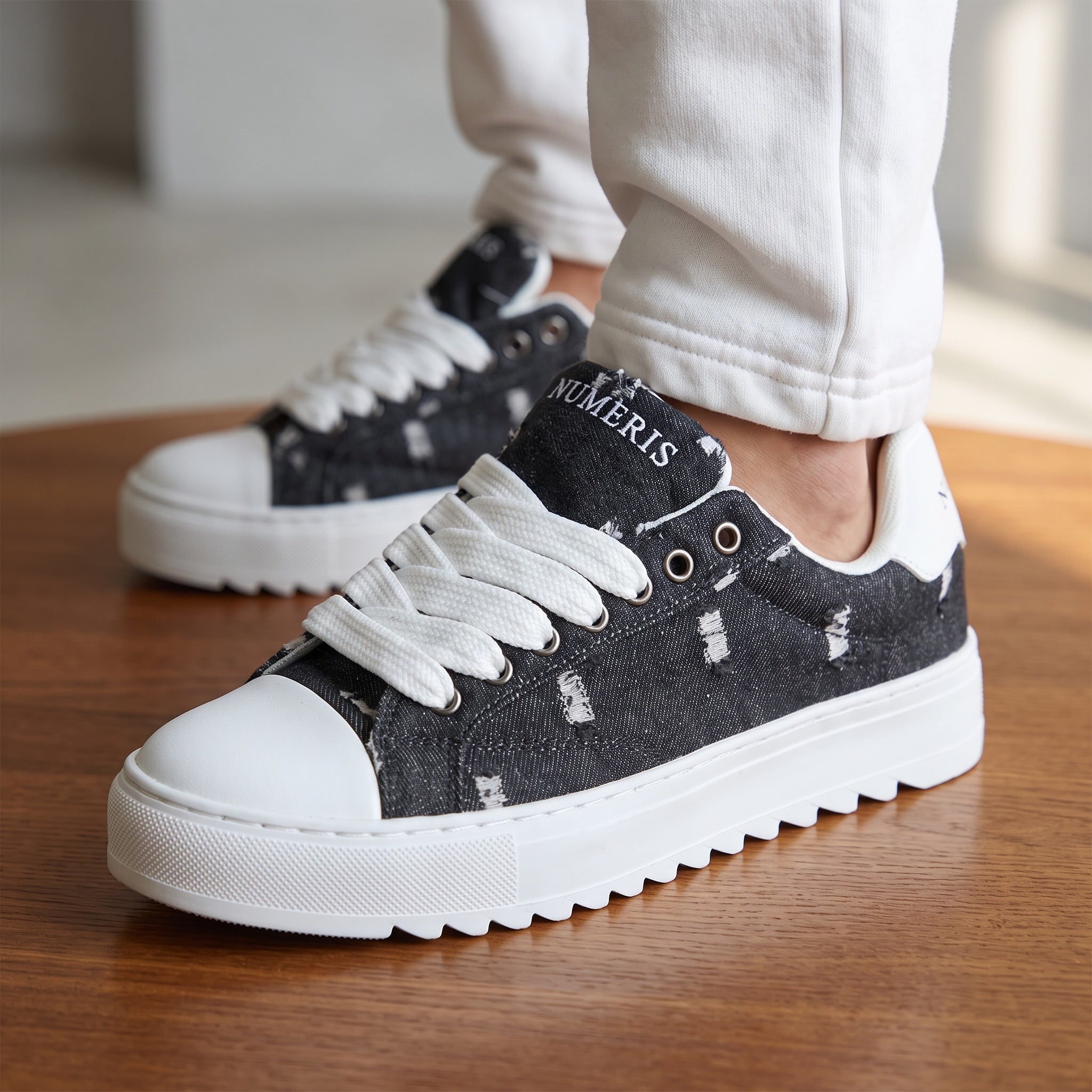 Numeris black distressed platform sneakers with white chunky sole and wide laces
