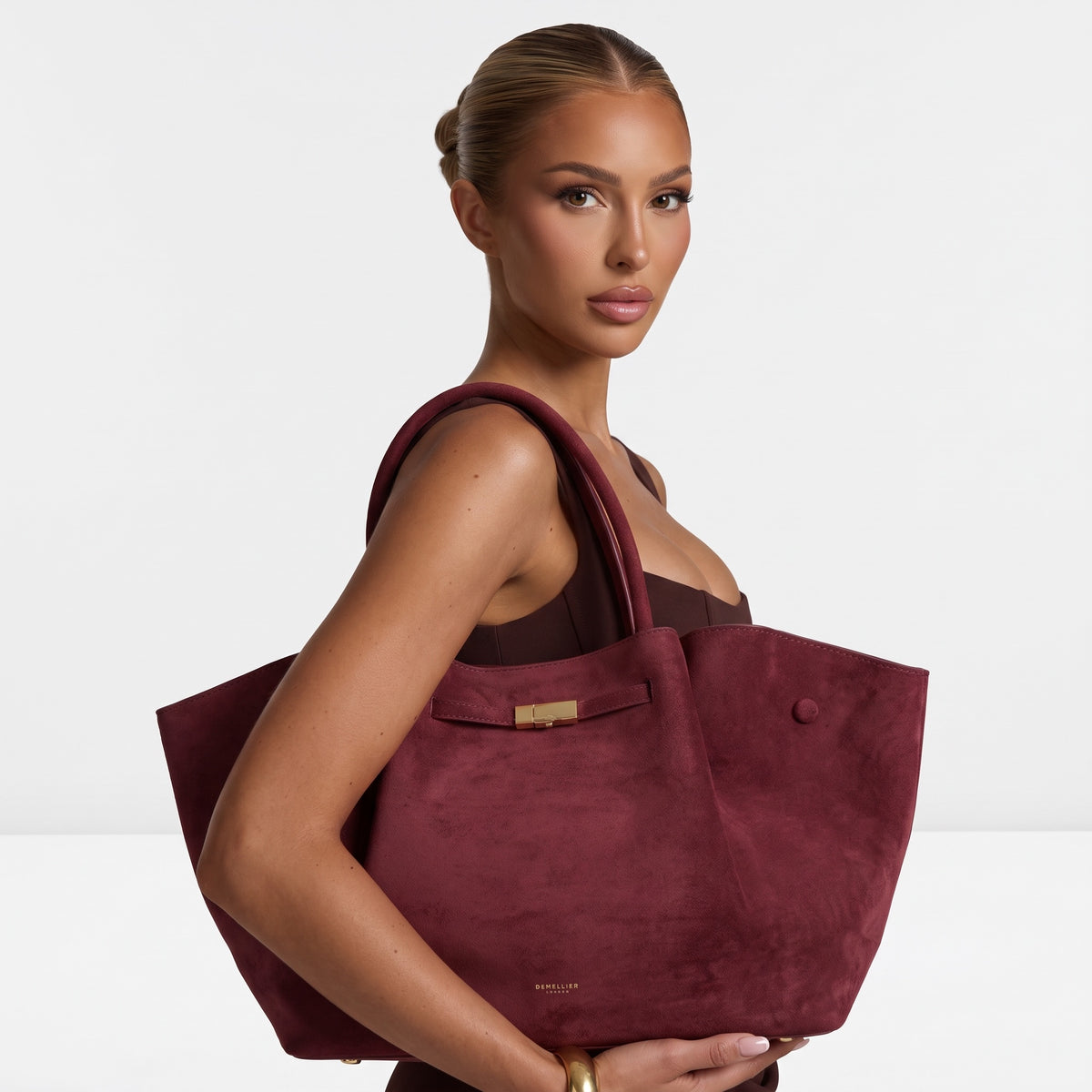 Demellier burgundy suede-effect sculpted tote with gold clasp and top handles